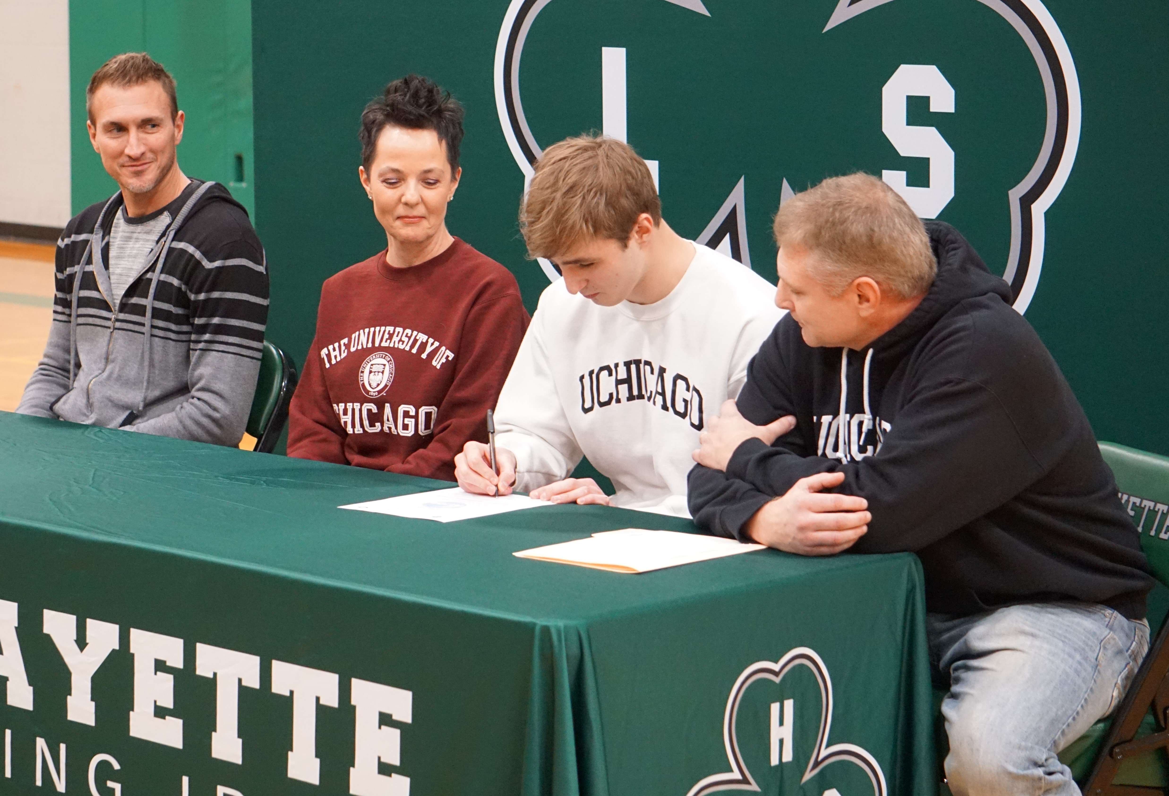 Lafayette's Jay Greiner (center, white shirt) signs his national letter of intent for University of Chicago wrestling at Lafayette High School Monday. Photo by Tommy Rezac.