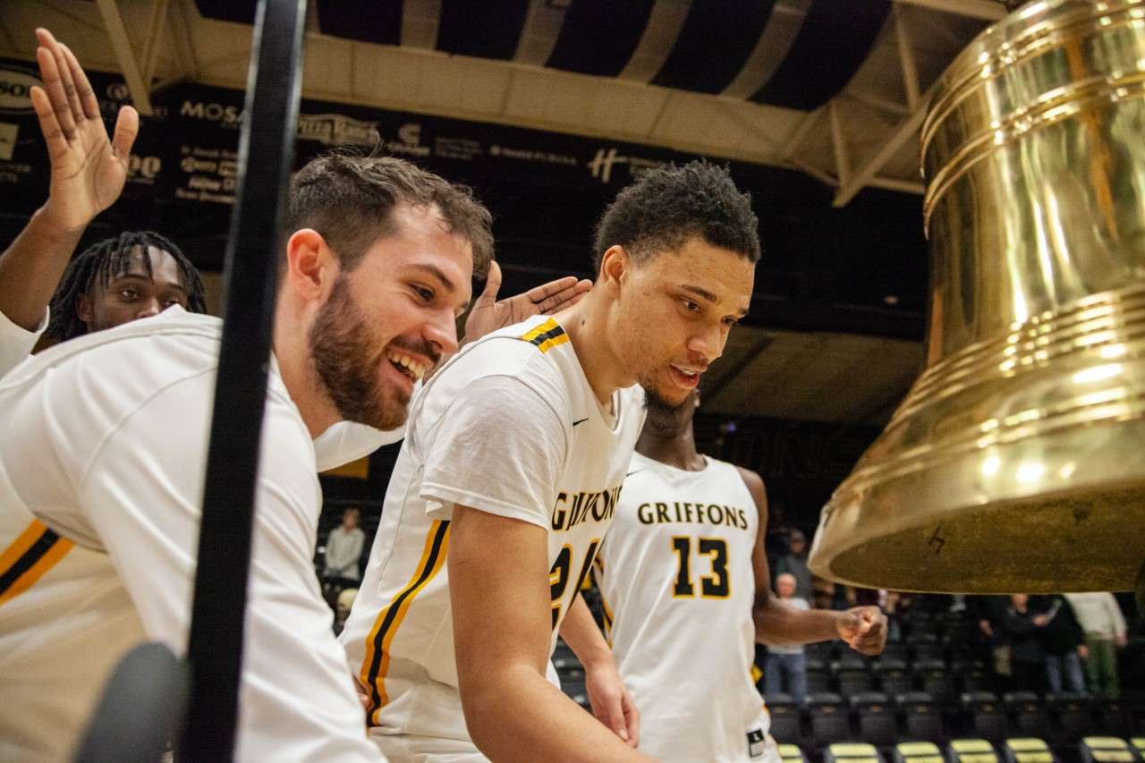 Missouri Western's Reese Glover (left) and JaRon Thames (right) ring the bell following the Griffons' 62-55 win over Fort Hays State on Tuesday. Photo by Arianne Boma.