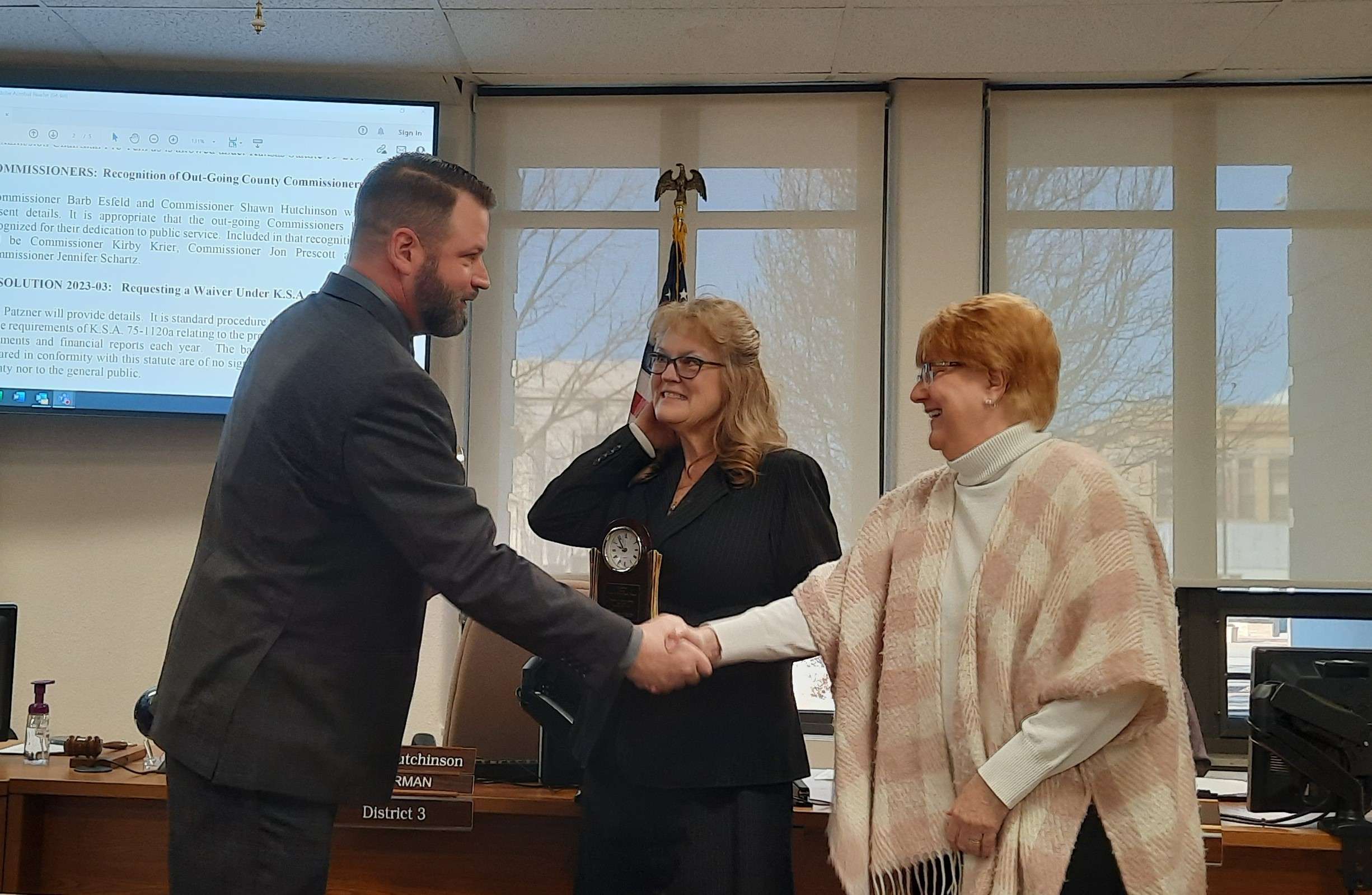 Commission Chair Shawn Hutchinson and Commissioner Barb Esfeld bid Jennifer Schartz farewell at the Jan. 9 Barton County Commission meeting.