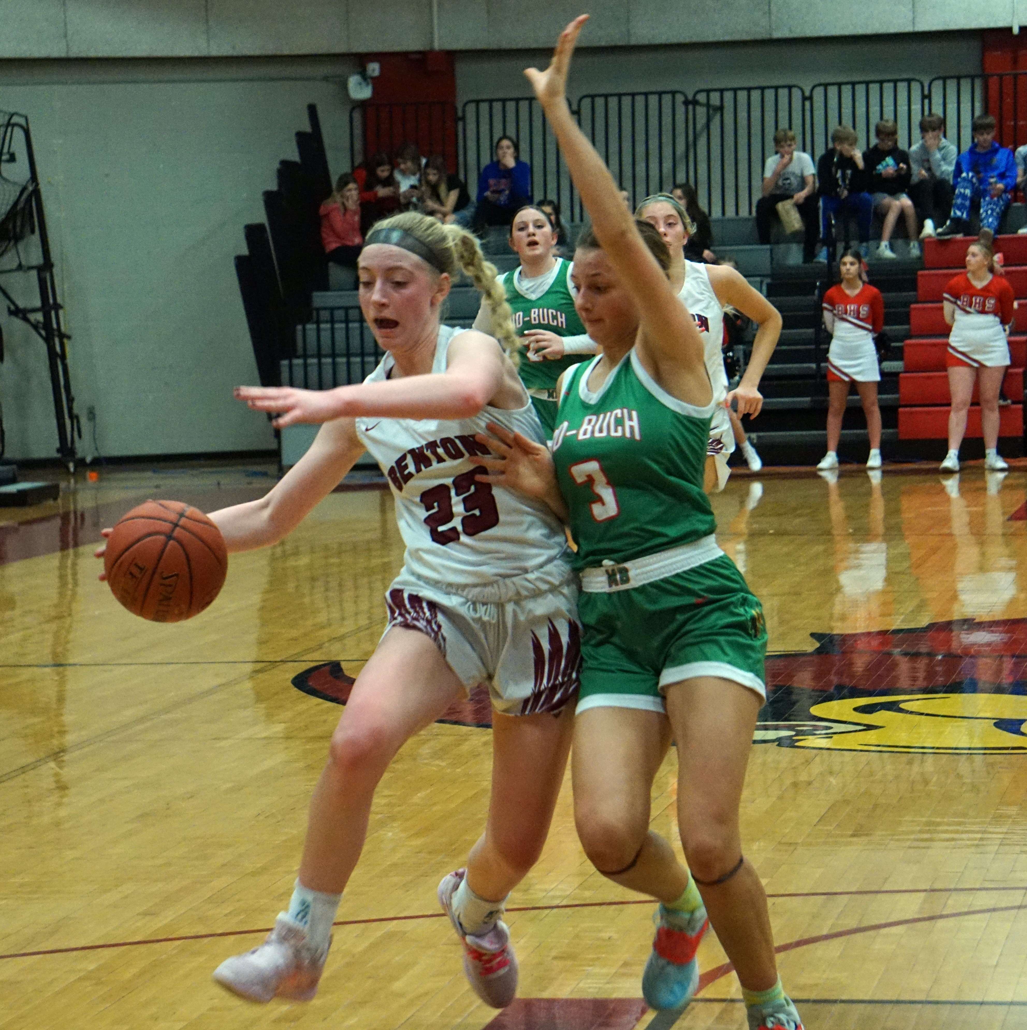 Andrea Simmons (23) fights off Mid-Buchanan's Liv Moeckli (3).