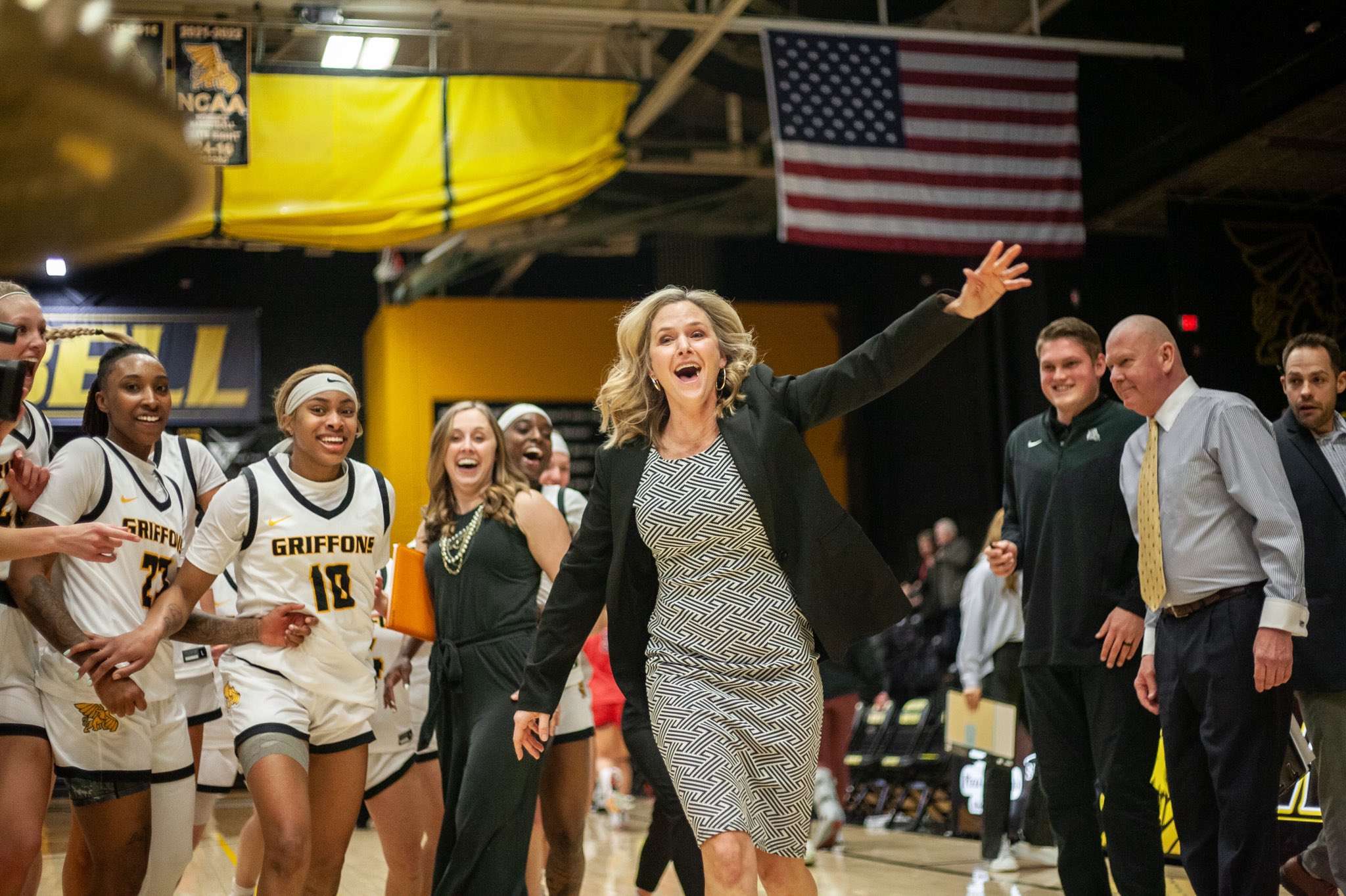 Missouri Western women's basketball coach Candi Whitaker and the Griffons celebrate a 66-63 win over No. 5 and previously undefeated Central Missouri on Saturday at the MWSU Fieldhouse. Photo by Arianne Boma.