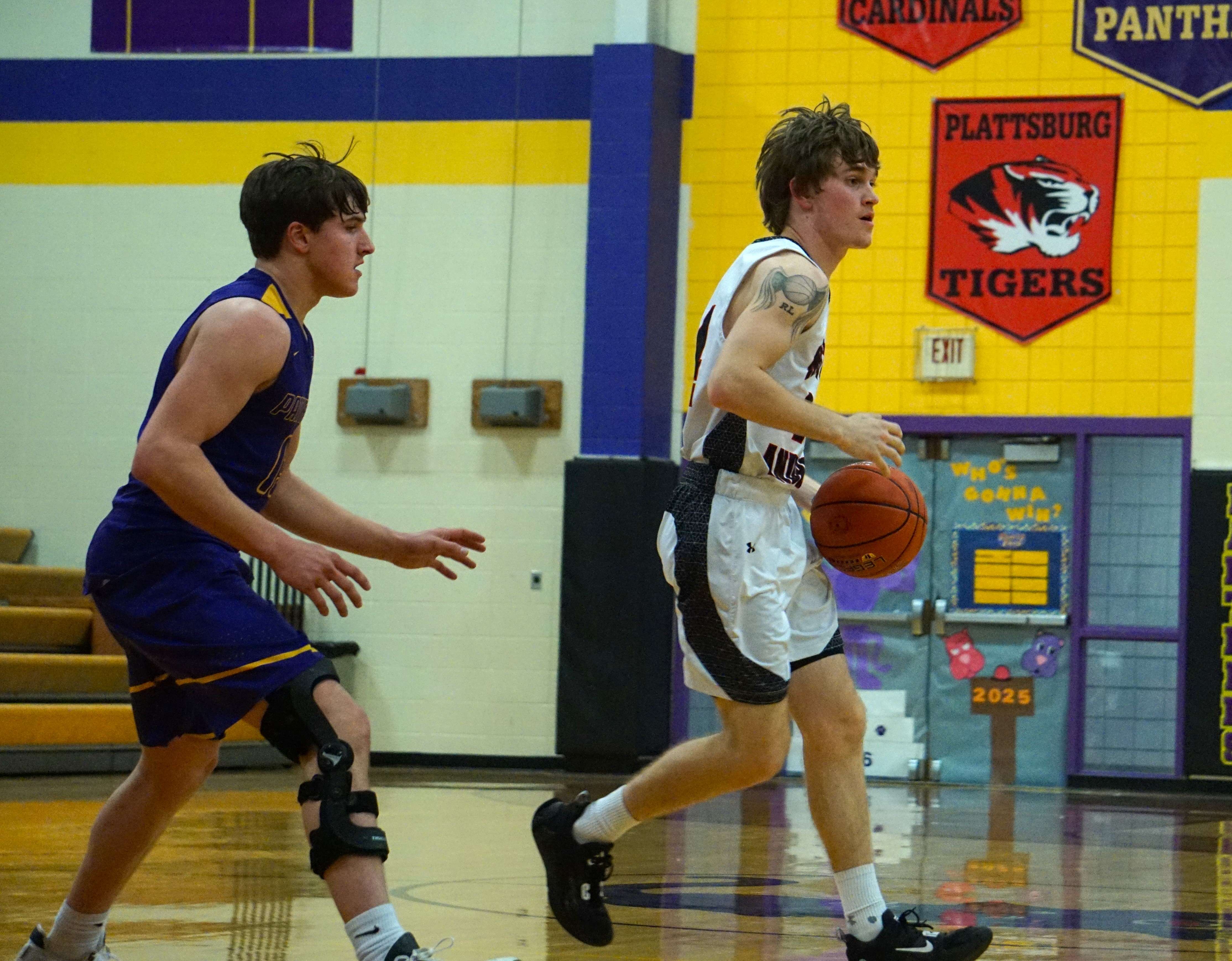 Hayden Ecker (right) dribbles the ball.