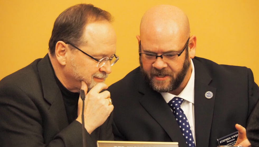 Rep. Stephen Owens, R-Hesston, right, confers with Rep. Tobias Schlingensiepen, D-Topeka, during a hearing Monday on juvenile justice reform. Owens said he is committed to fixing issues within the juvenile justice system. (Rachel Mipro/Kansas Reflector) 