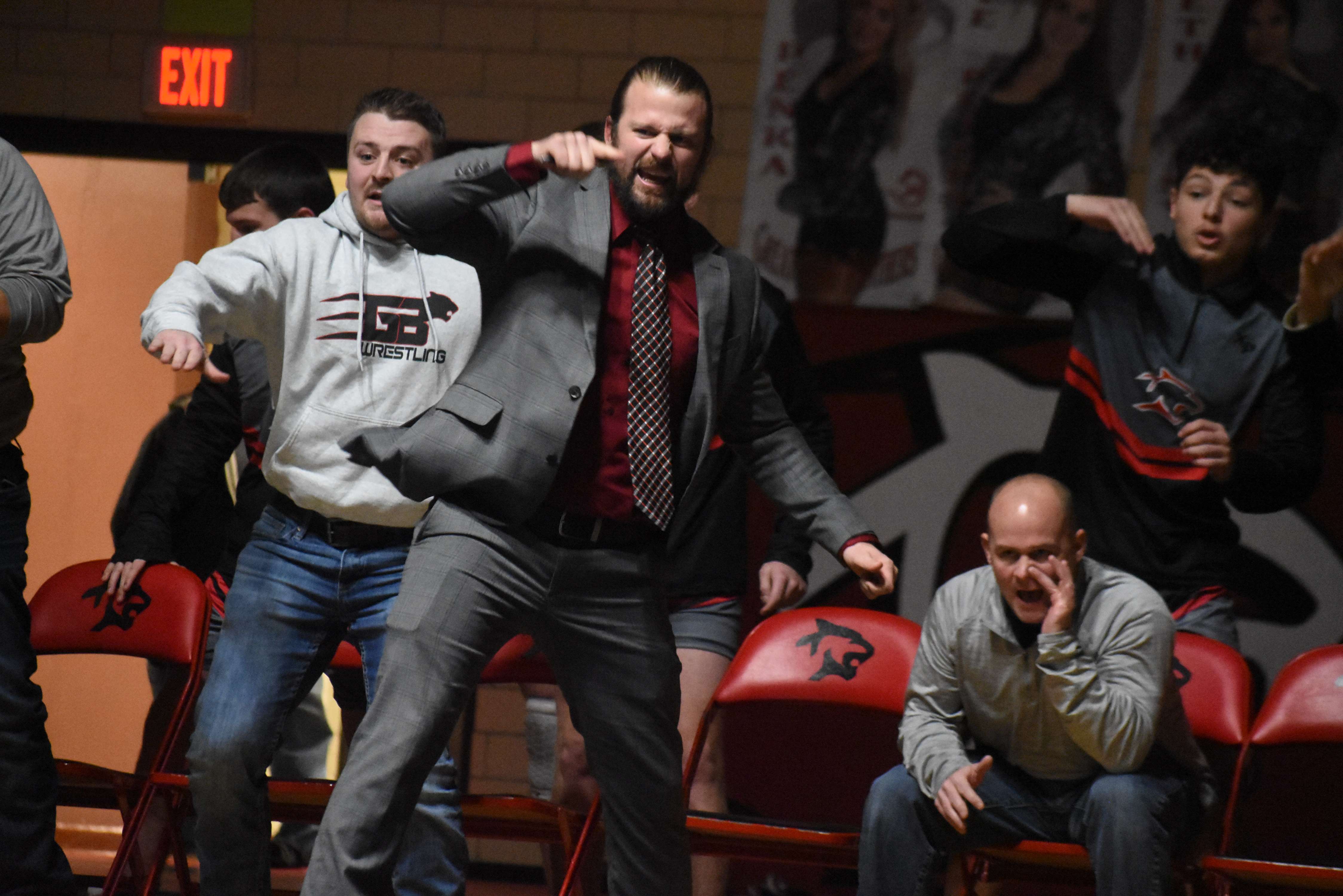 Panther Coach Nathan Broeckelman and the bench erupt as Kelly prepares to pin his opponent at 126 pounds.