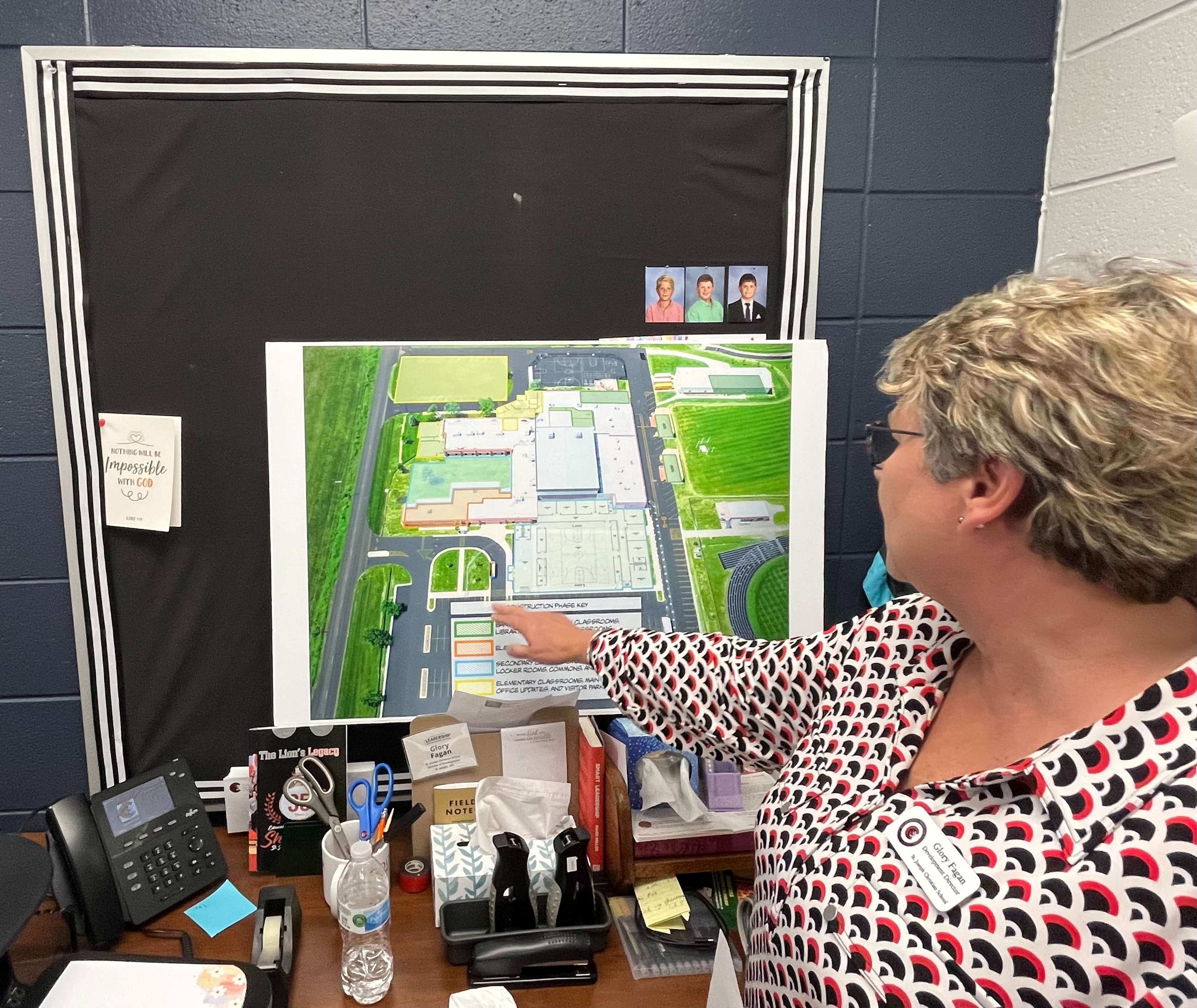 Glory Fagan points out the different portions of the Nehemiah Building Project at St. Joseph Christian. Photo by Tommy Rezac.