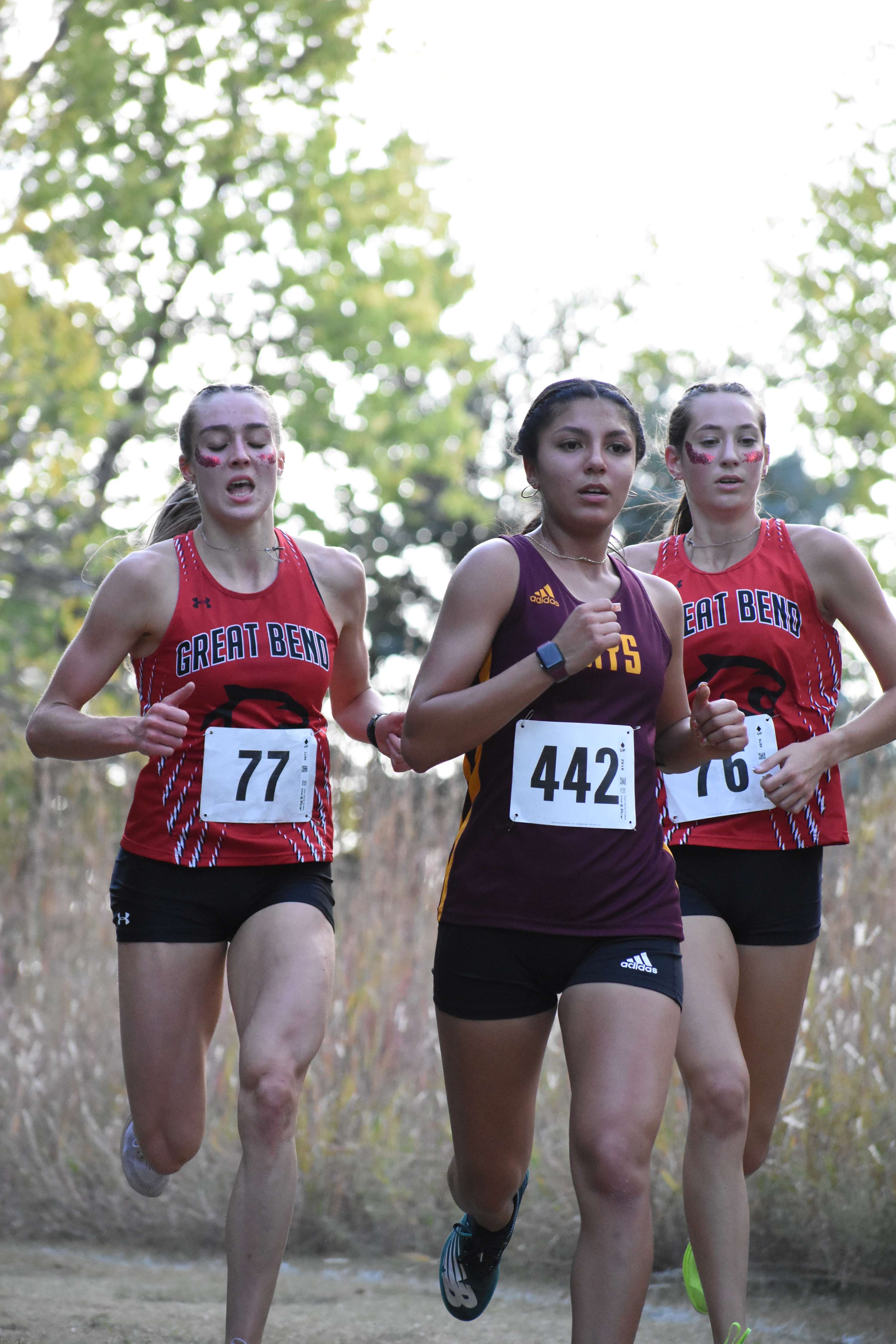 Hays' Arely Maldonado broke up Great Bend's perfect day in second but Panther seniors Addy Nicholson (right) and Makenzie Premer finished first and third, respectively.