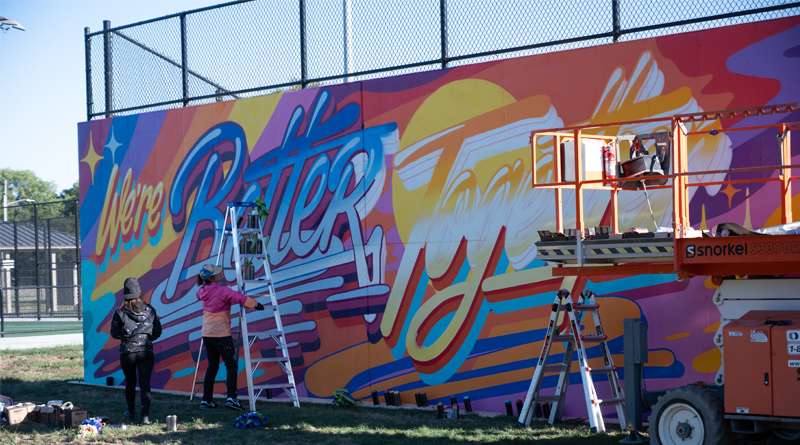 New York based artist Queen Andrea, or Andrea von Bugdoss finishes her mural for the BOOM! 2023 Mural Festival with her assistant on Saturday, Oct. 7, in Salina. Photo by Olivia Bergmeier