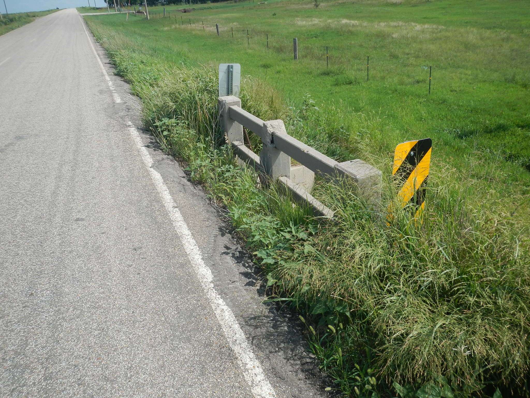 A large drop-off sits just a few feet from the edge of NE 130 Ave.