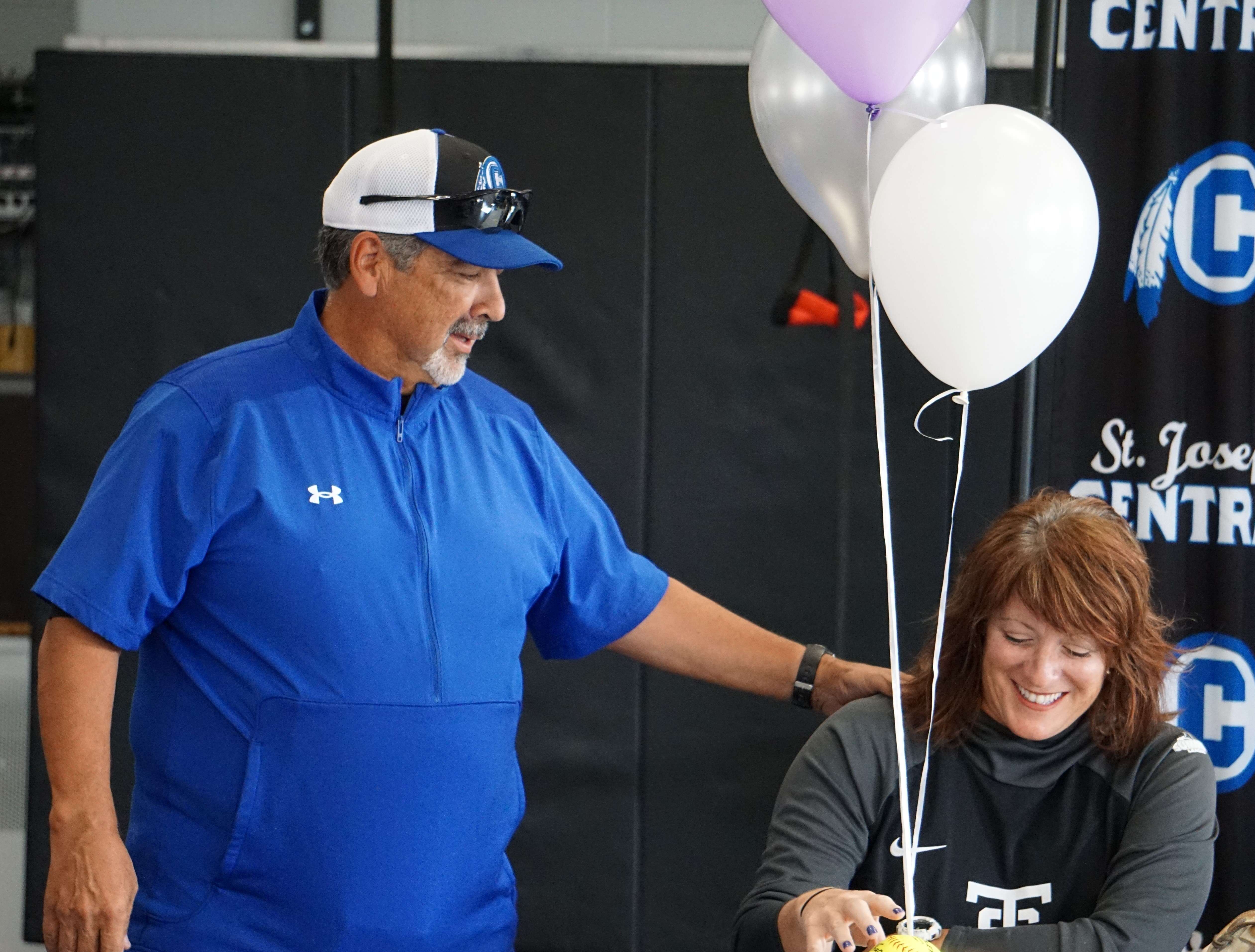 Central softball coach Buzz Verduzco (left) and St. Thomas softball coach Jen Bagley-Trotter (right) share a moment at Zoe Trotter's signing Thursday. The two worked together at Missouri Western for two decades. Photo by Tommy Rezac.