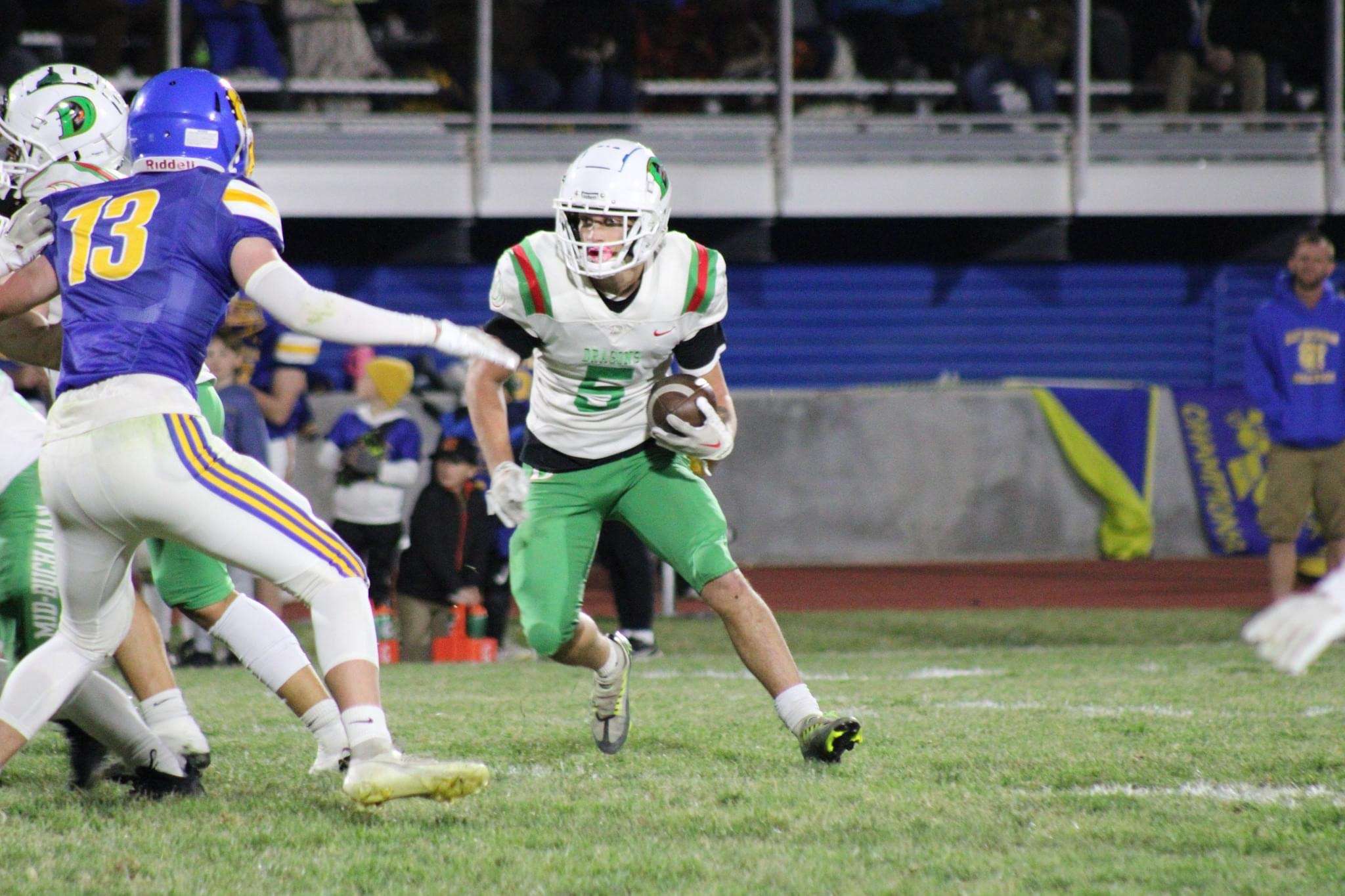 Mid-Buchanan running back Ian Wegenka (5) works his way around a pursuing Aidan Rhoad