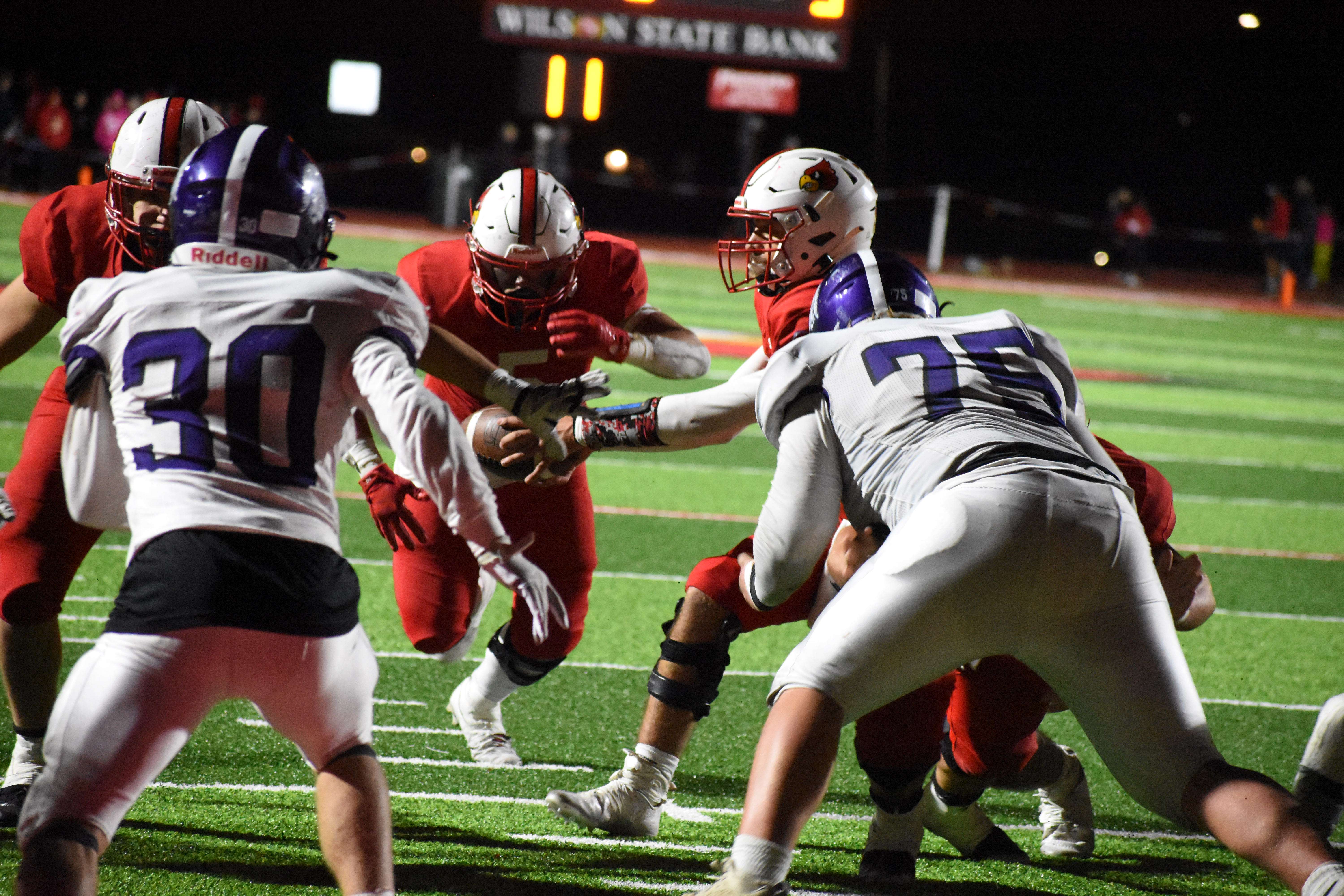 Cardinal senior Tony Moore hands the ball off to Teron Kraft during Friday's 49-42 sectional win against unbeaten Southeast of Saline. The pair combined for 286 rushing yards and four touchdowns, and Moore threw for another 158 yards and a touchdown.