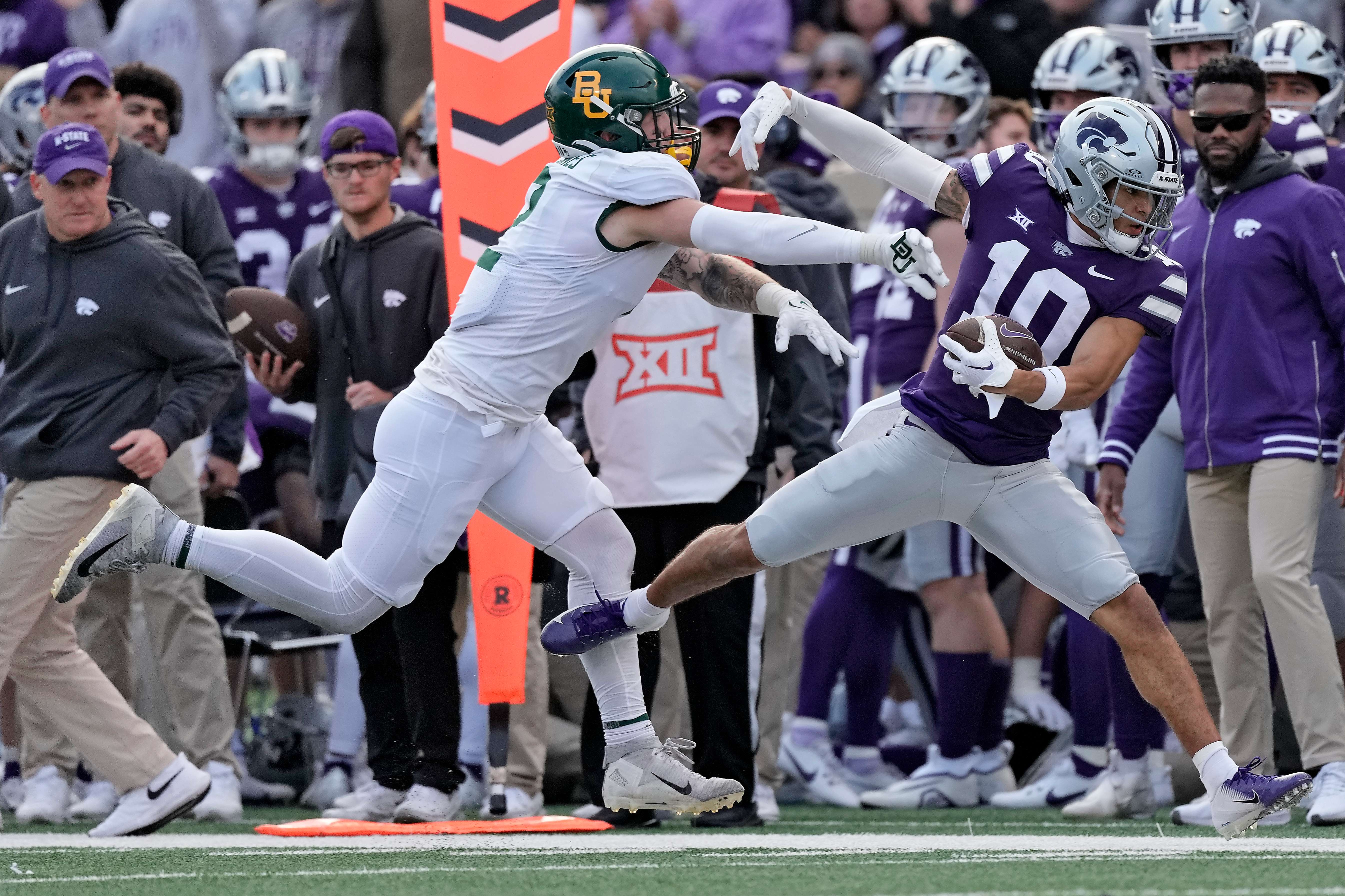 Kansas State wide receiver Keagan Johnson (10) is pushed out of bounds by Baylor linebacker Matt Jones after catching a pass during the first half of an NCAA college football game Saturday, Nov. 11, 2023, in Manhattan, Kan. (AP Photo/Charlie Riedel)