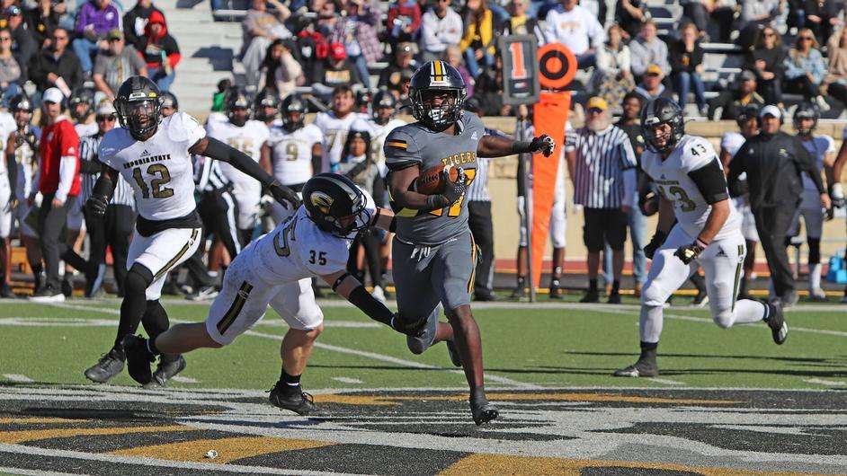 Fort Hays State running back Travis Dixon (17) runs past Emporia State's Bo Odom (35) in an NCAA football game in Hays, Kan., Saturday, November 11, 2023. (FHSU Athletics photo/Gillian Lynch)