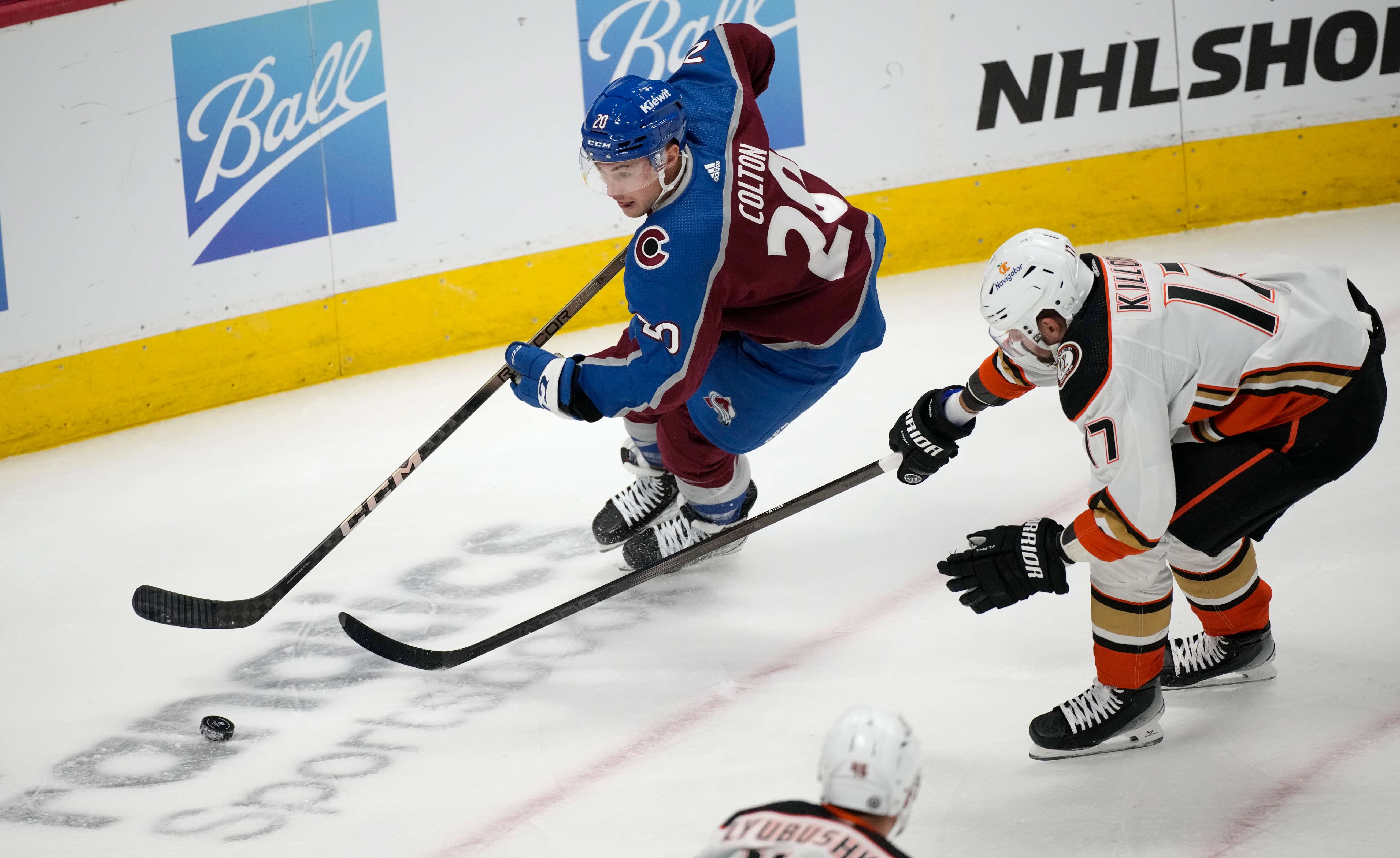 Colorado Avalanche center Ross Colton, left, drives to the net with the puck as Anaheim Ducks left wing Alex Killorn pursues in the first period of an NHL hockey game Wednesday, Nov. 15, 2023, in Denver. (AP Photo/David Zalubowski)