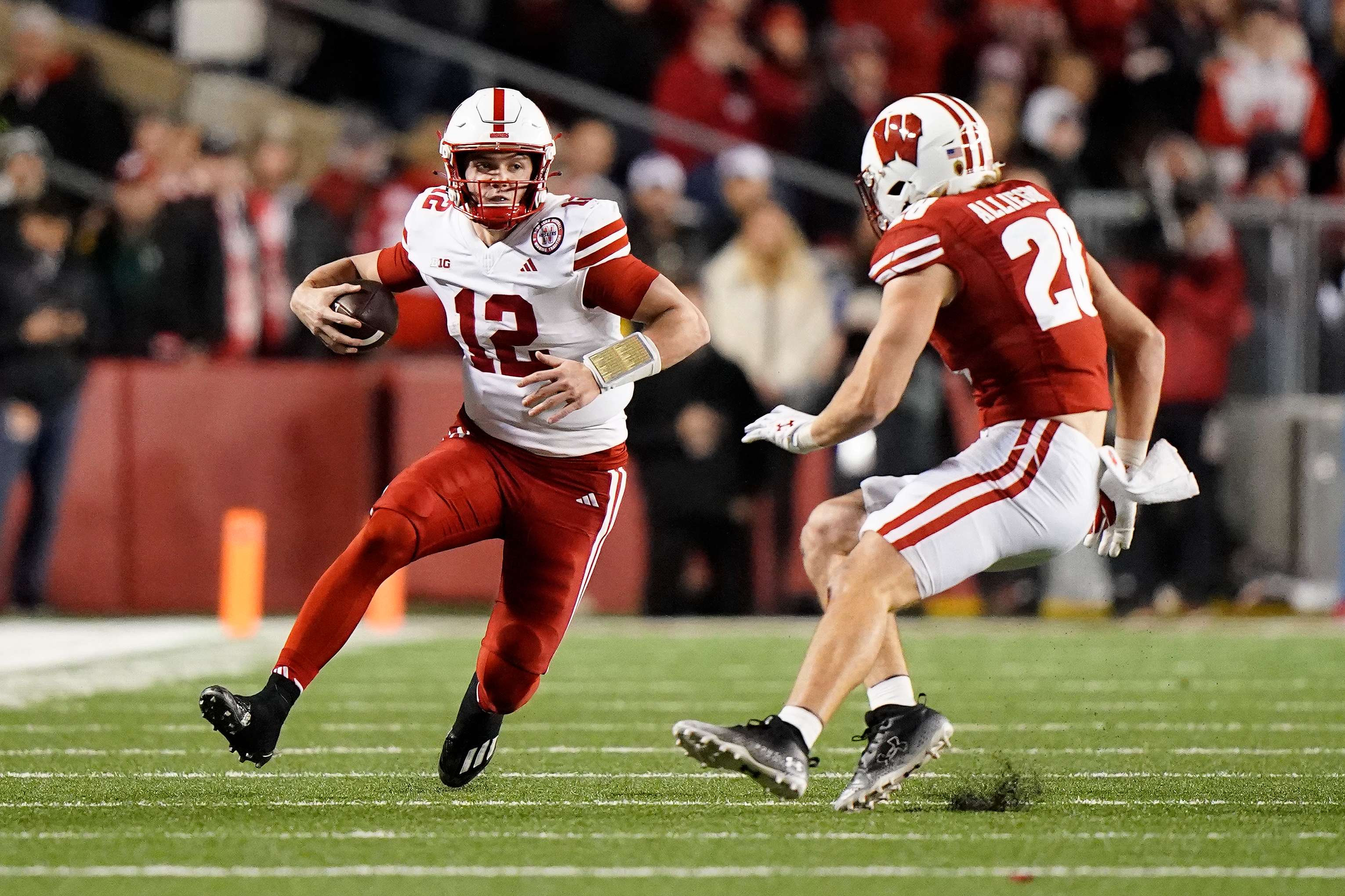 Nebraska's Chubba Purdy (12) runs against Wisconsin's Christian Alliegro during the second half of an NCAA college football game Saturday, Nov. 18, 2023 in Madison, Wis. (AP Photo/Aaron Gash)