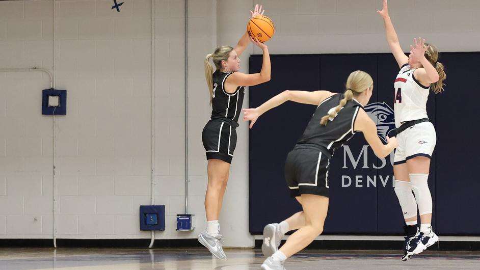 Fort Hays State guard Sydney Golladay attempts a 3-point shot over&nbsp; MSU Denver's Brooklynn Jones (14) in the first half of an NCAA basketball game against MSU Denver in Denver, Monday, November 20, 2023. (FHSU Athletics photo/Edwards Jacobs Jr.)