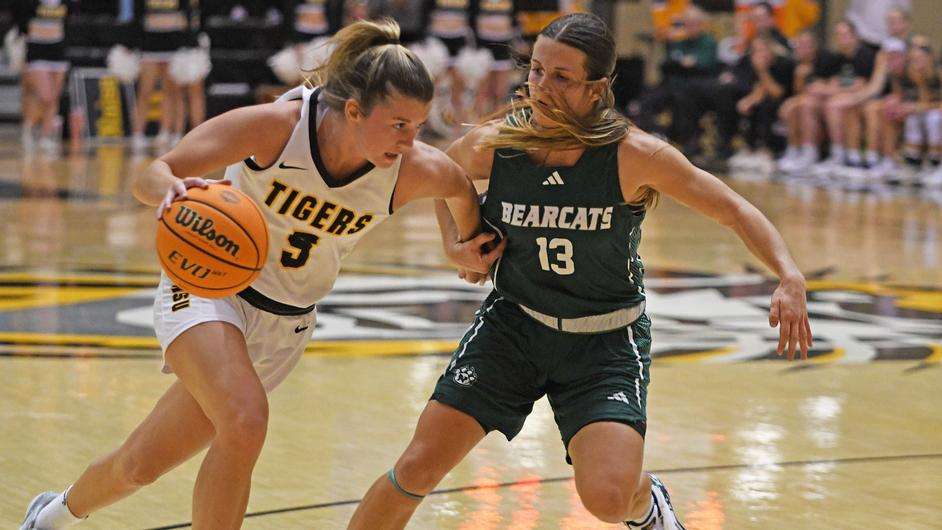 Fort Hays State's Brooke Loewe (5) drives to the basket against NW Missouri State's Caely Keston (13) in the second half of an NCAA basketball game on Thursday, December 7, 2023 in Hays, Kan. (FHSU Athletics photo/Nicole Heitmann)
