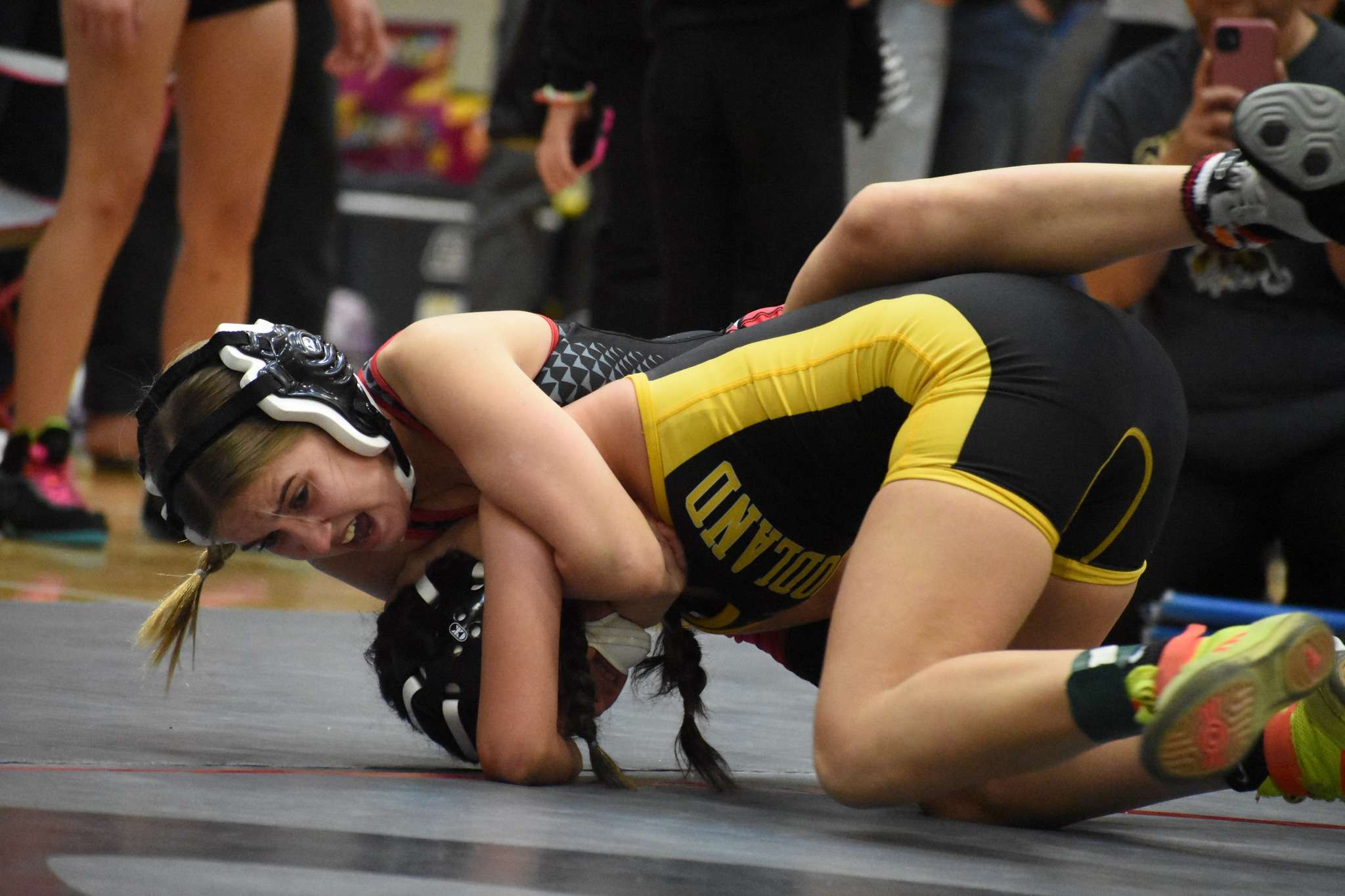 Lady Panther freshman Trinaty Aumiller works her way to a pin against Goodland's&nbsp; Kaylee Hernandez in round one of the Christmas Clash Friday in Great Bend.