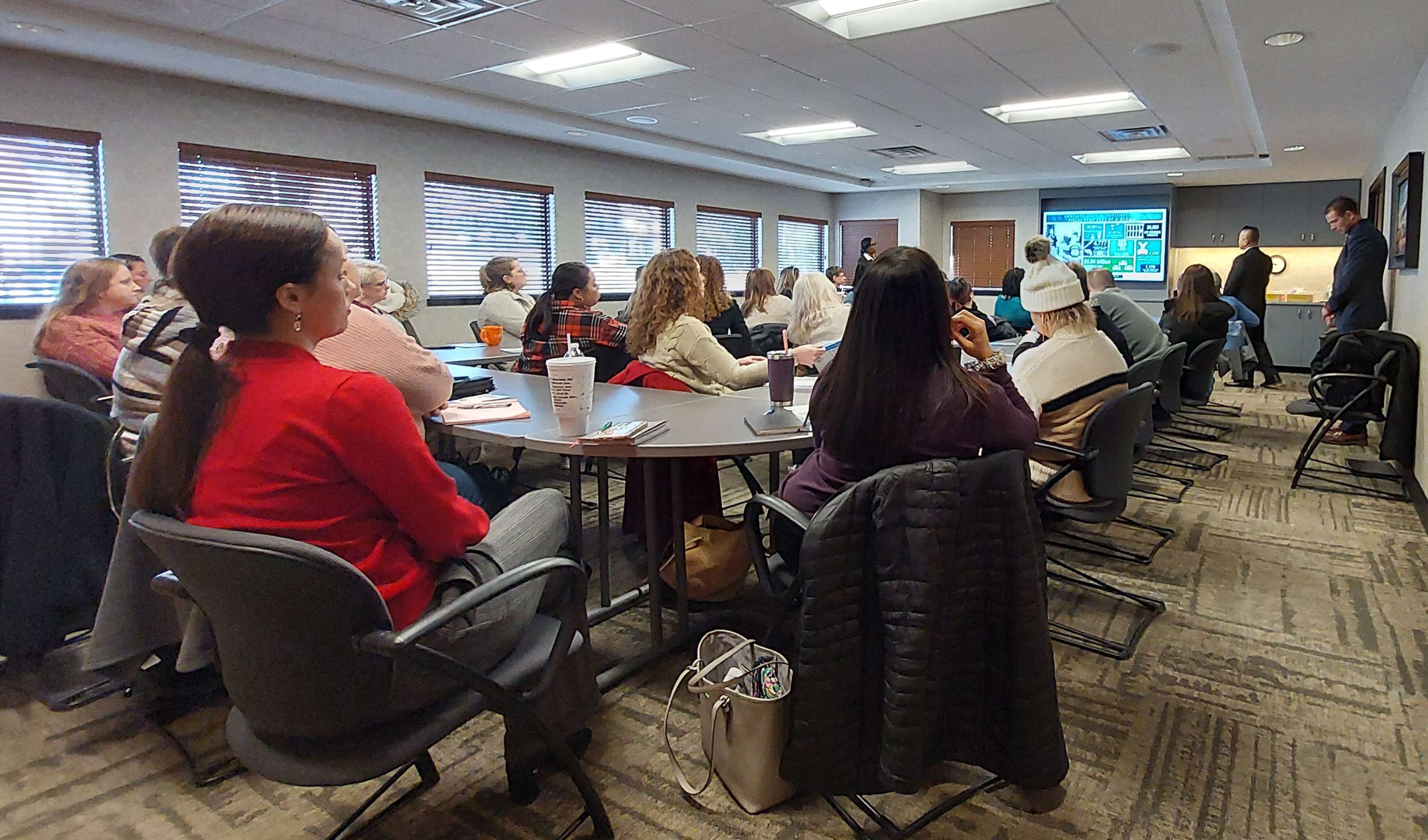 Northwest Missouri State University Small Business Development Center director Rebecca Lobina (in red) looks on during a presentation on human trafficking by the Department of Homeland Security/ Photo by Matt Pike