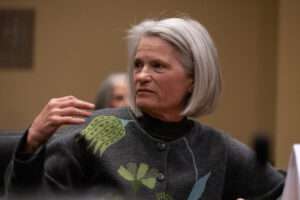 Ann Seacreast, a registered nurse and lactation consultant, motions to State Sen. Carol Blood while testifying before the Health and Human Services on Wednesday, Feb. 1, 2023, in Lincoln. (Zach Wendling/Nebraska Examiner)