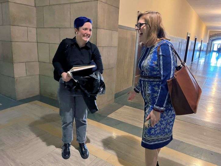 Eliana Seibe-Walles, 20, of Lincoln, speaks to Omaha Sen. Machaela Cavanaugh outside a hearing for a bill that would allow medical providers, facilities and insurers to cite their religious, ethical or moral beliefs in denying some medical treatments, Friday, Feb. 10, 2023 in Lincoln, Neb. Seibe-Walles spoke out against the bill, saying she fears it could be used by medical staff to discriminate, especially against people of color and queer people who are already more burdened than others when it comes to getting the care they need." (AP Photo/Margery Beck)