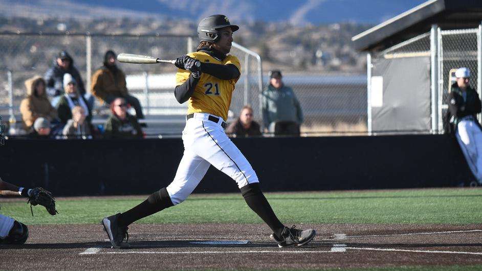 Fort Hays State junior outfielder Zack Davis (21) gets a hit vs. Adams State on February 3, 2023 in Colorado Springs, Colo. (FHSU Athletics photo)