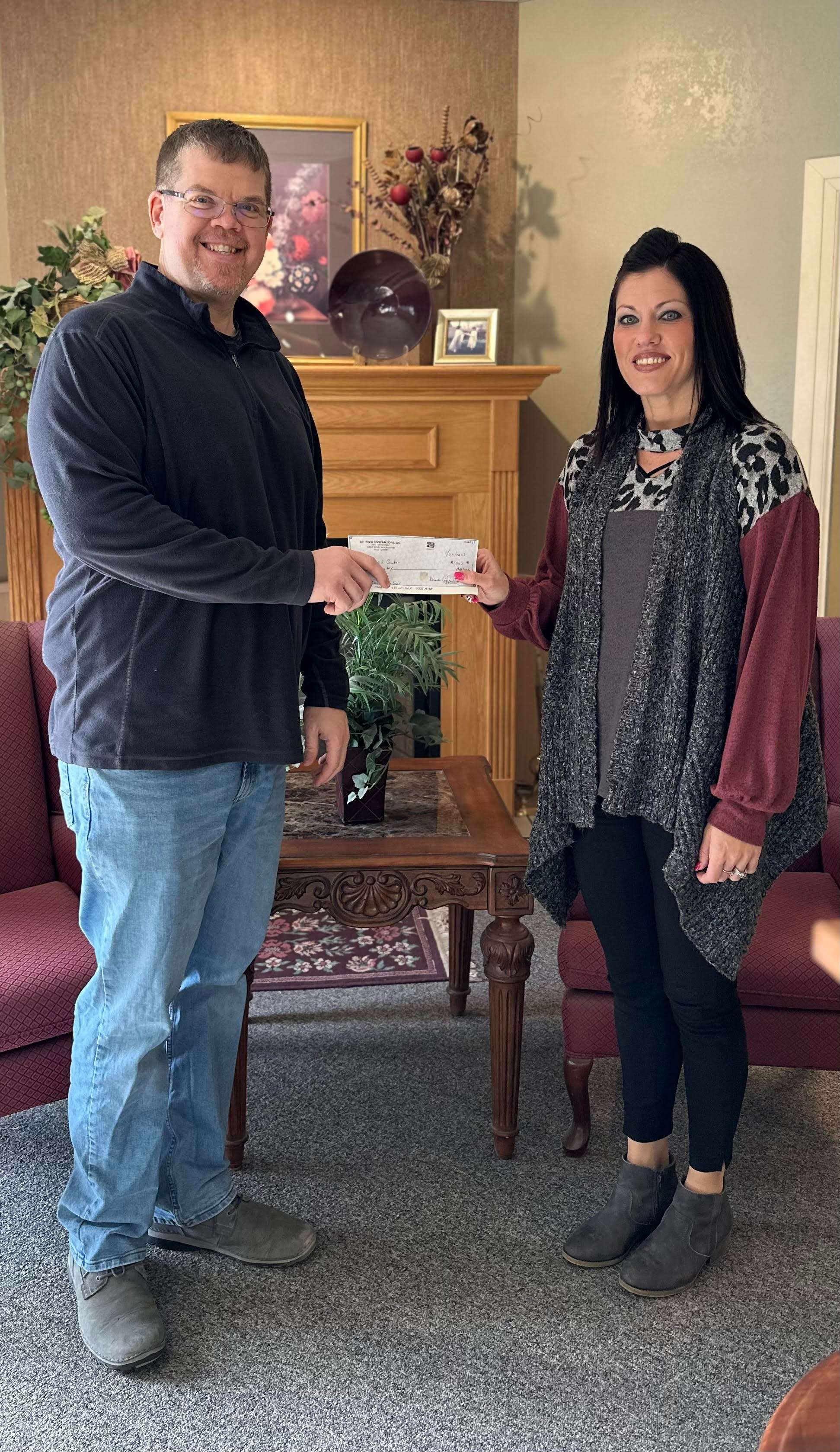 Stueder Contractors presents a $1,000 check in sponsorship of the March 31, Red Shoes & BUNCO event. Pictured is Rusty Newton, Dispatcher and AP Clerk at Stueder Contractors and Kylee Graves, Executive Director of the Family Crisis Center. To purchase tickets or support the cause, visit <a href="http://www.familycrisiskansas.com/" target="_blank">www.familycrisiskansas.com</a>. 