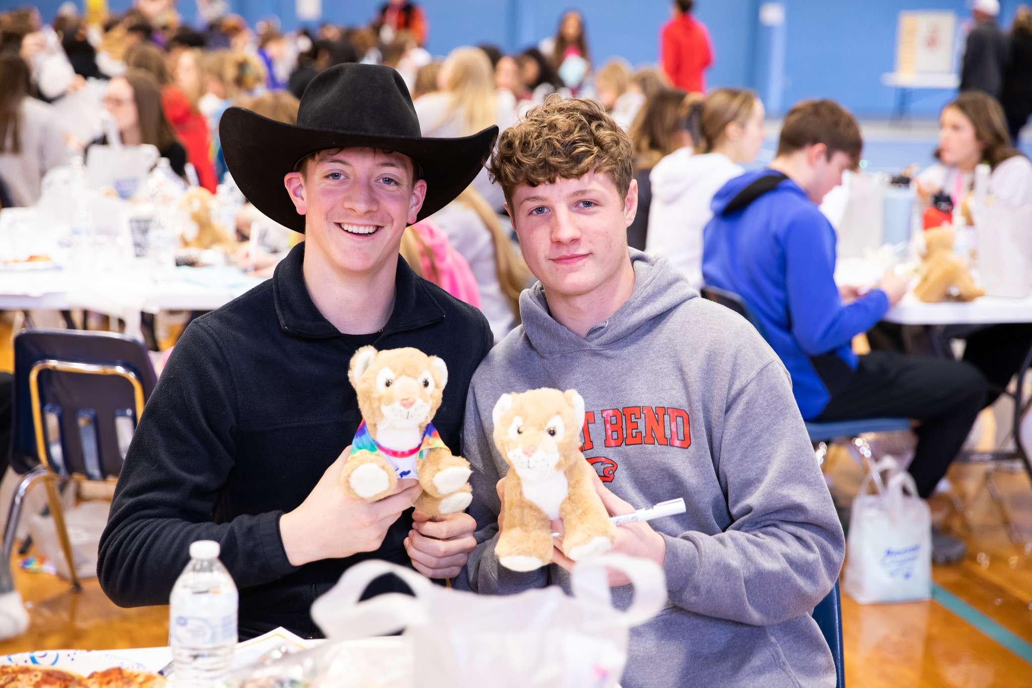 A pair of Junior Day attendees holds up their “Build-A-Cougar” plushies Wednesday on the Barton Campus.