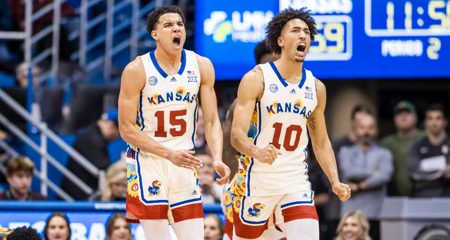 Kansas guard Kevin McCuller, Jr. (15) and forward Jalen Wilson (10) celebrate during a Big 12 game vs. Baylor on February 18, 2023 in Lawrence, Kan. (Kansas Athletics photo)