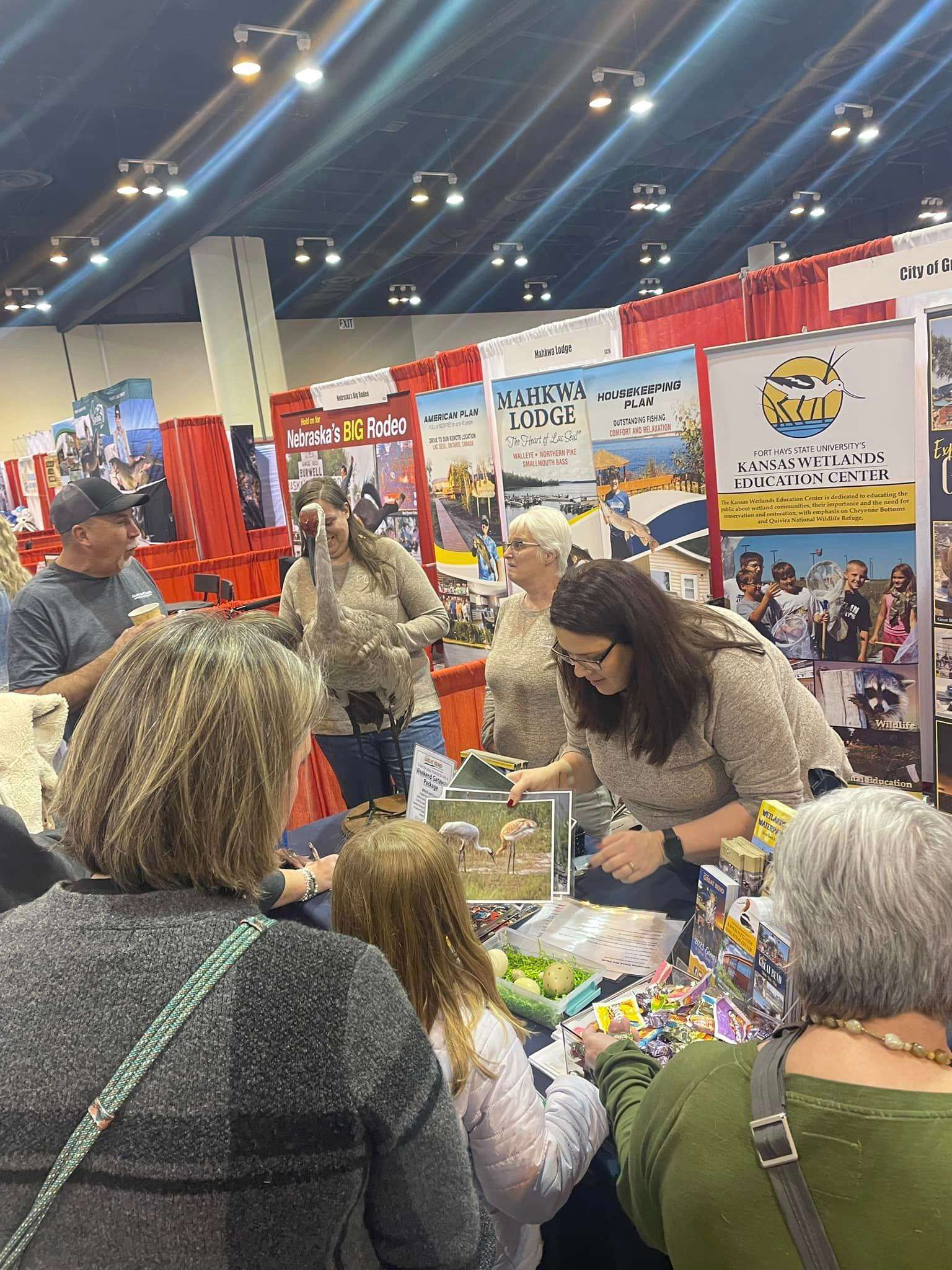Great Bend Convention & Visitors Bureau's Amanda Gaddis teaches potential tourists about Cheyenne Bottoms at the Omaha International Boat Sports & Travel Show.