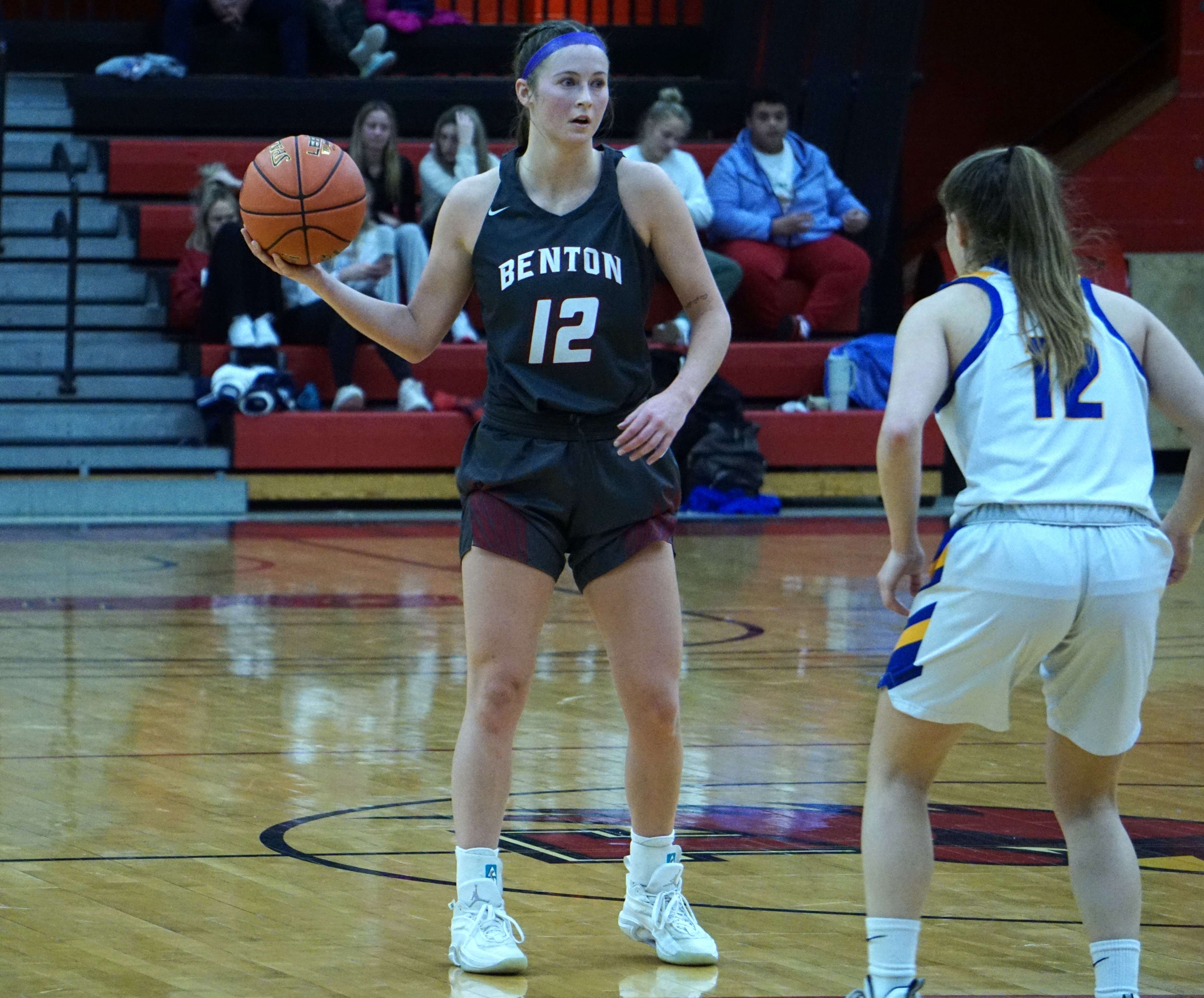 Peyton Anderson (12) holds the ball in the backcourt.