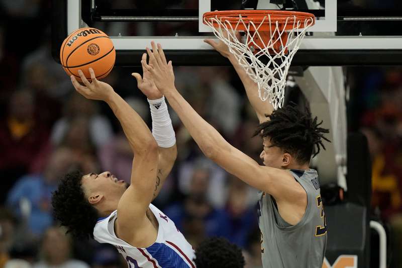 <b>Kansas forward Jalen Wilson, left, shoots under pressure from West Virginia forward James Okonkwo during the first half of Jayhawks-Mountaineers game in the second round of the Big 12 Conference tournament Thursday in Kansas City, Mo. </b>(AP Photo/Charlie Riedel)