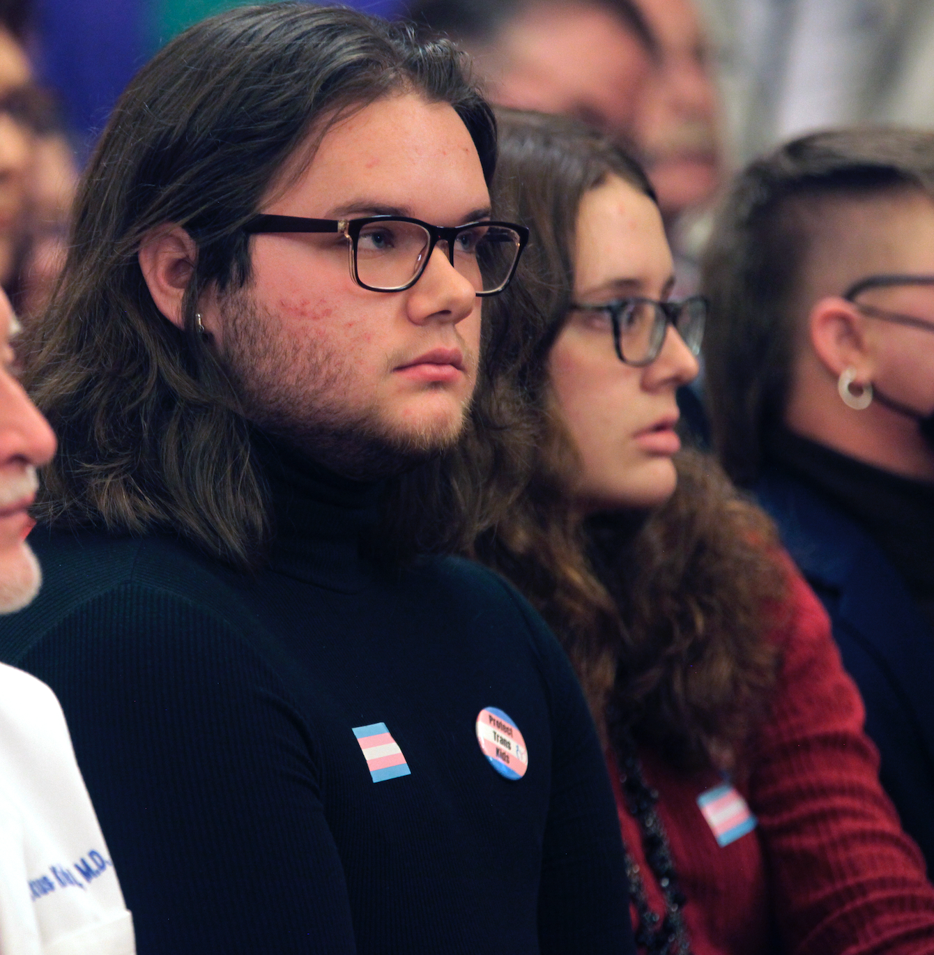 -Adam Kellogg, a University of Kansas student and transgender man, follows a Kansas Senate health committee hearing on legislation aimed at preventing gender-affirming care for minors, Tuesday, Feb. 14, 2023, at the Statehouse in Topeka, Kan. The Republican-controlled Kansas Legislature is also considering a measure to define male and female in state law in such a way that it could prevent transgender men and women from changing their driver's licenses and birth certificates. (AP Photo/John Hanna)