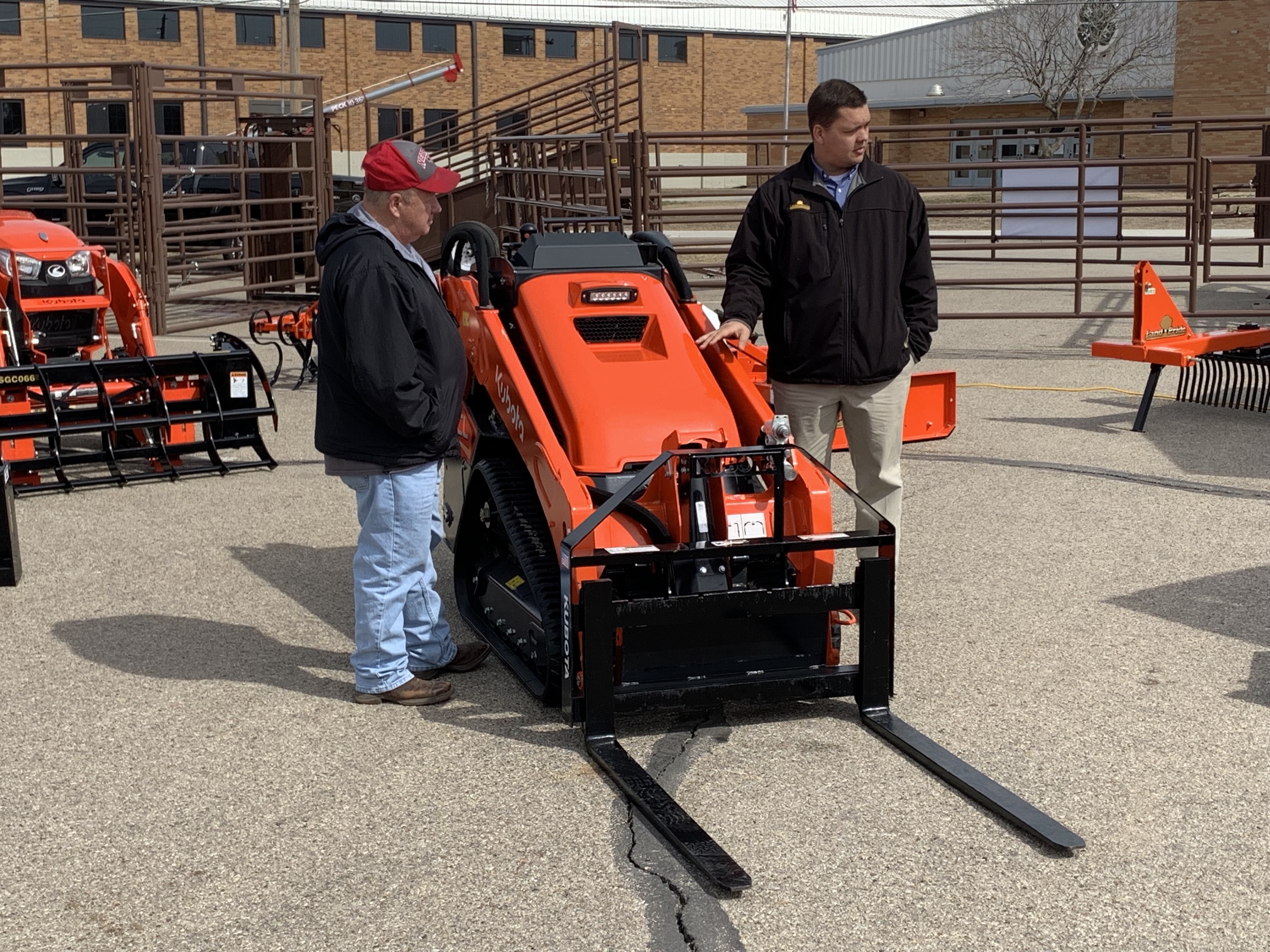 <b>Howze explains the various features of Land Pride's Kubota stand on compactor with a forklift attachment. Howze said of all the implements on display, expo attendees were most interested&nbsp;in the </b><a href="https://www.kubotausa.com/products/construction/track-loaders">track loader.&nbsp;</a>