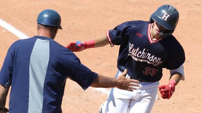 Colin Cymbalista is greeted by Blue Dragon third base coach Deron McCue after hitting one of his five home runs in a doubleheader split with Cowley on Thursday at Hobart-Detter Field. (Billy Watson/Blue Dragon Sports Information)