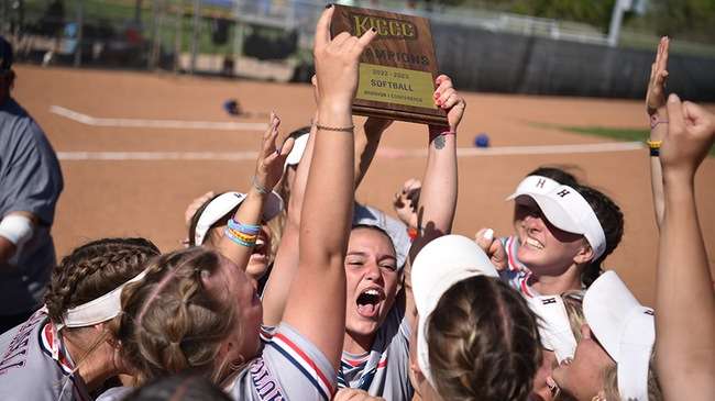 The Blue Dragon softball team raises the 2023 Jayhawk Conference championship trophy after a doubleheader sweep of Pratt on Saturday at Fun Valley. (Steve Carpenter/Blue Dragon Sports Information)<br>
