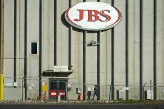 A worker heads into the JBS meatpacking plant in Greeley, Colo., Oct. 12, 2020. Packers Sanitation Services Inc. (PSSI), the slaughterhouse cleaning company that was found to be employing more than 100 children to help sanitize dangerous razor-sharp cutting equipment like bone saws, has continued to lose contracts with the major meat producers since the investigation became public in the fall of 2022. Cargill, Tyson Foods and JBS have all terminated contracts with PSSI at at least some of their plants. (AP Photo/David Zalubowski, File)