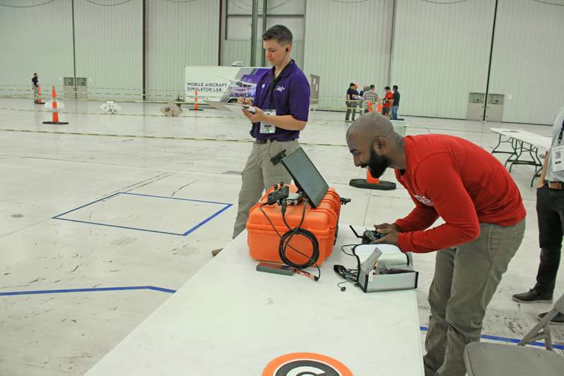 <b>A member of one of the nine teams uses a monitor and hand controls to fly a drone during the competition Wednesday. </b>Photos courtesy K-State Salina