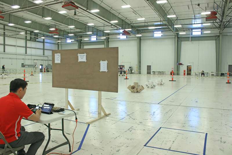 <b>A team member flies a drone (right center) during the competition Wednesday.</b>