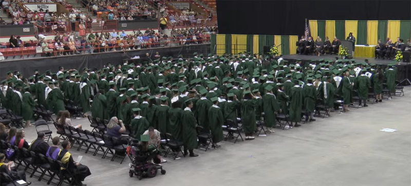 <b>Members of the Salina South Class of 2023 stand to move their tassels to the other side of their caps at the conclusion of the graduation ceremony.</b> Still photos pulled from live stream video shot by Salina Media Connection for USD 305