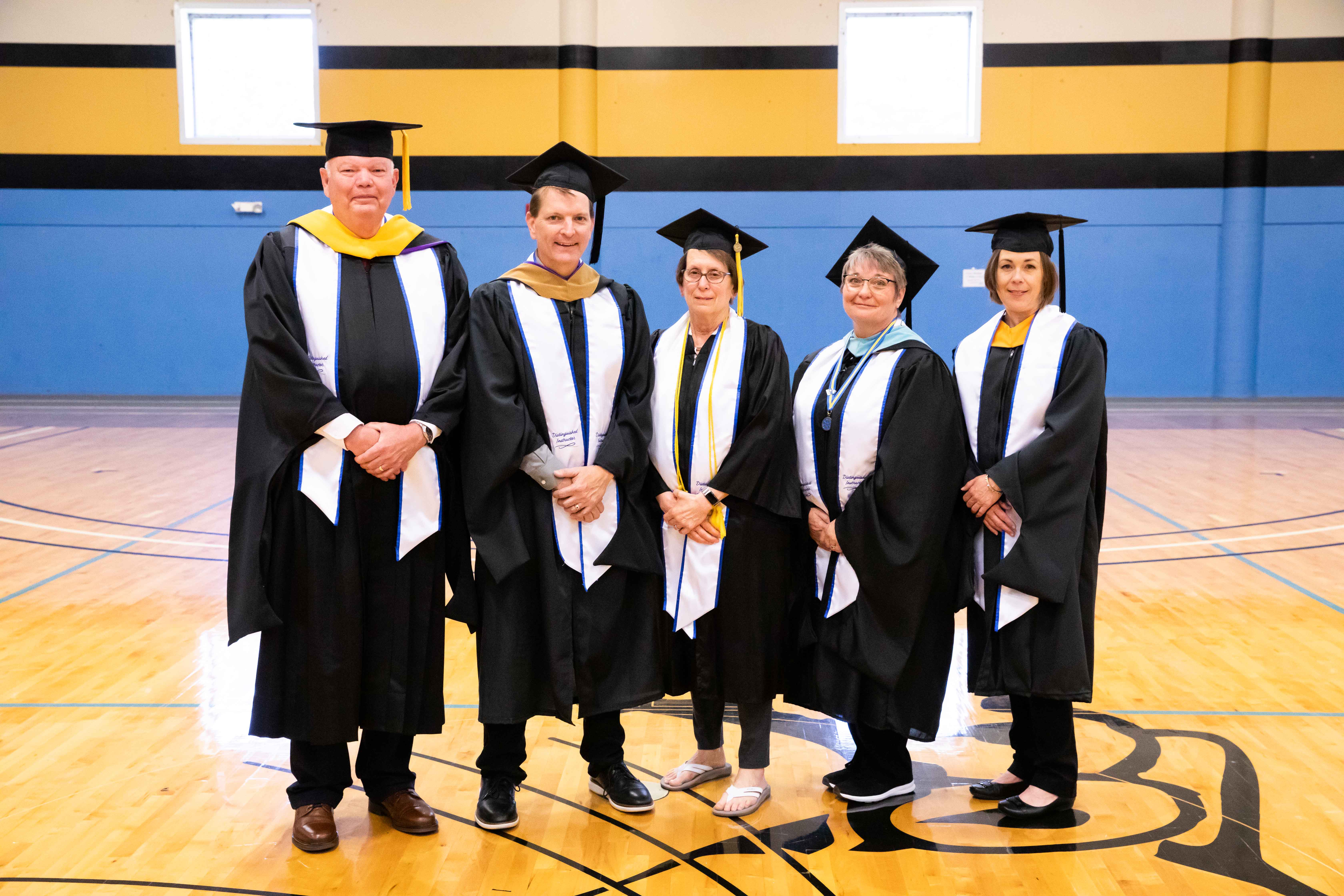(from left) Barton 2023 Distinguished Instructors James Hill, Jason Murray, Sue Simmons, Roni Wertz, and Kara Brauer pose for a photo before the Barton commencement ceremony Friday night in the Barton Gymnasium.