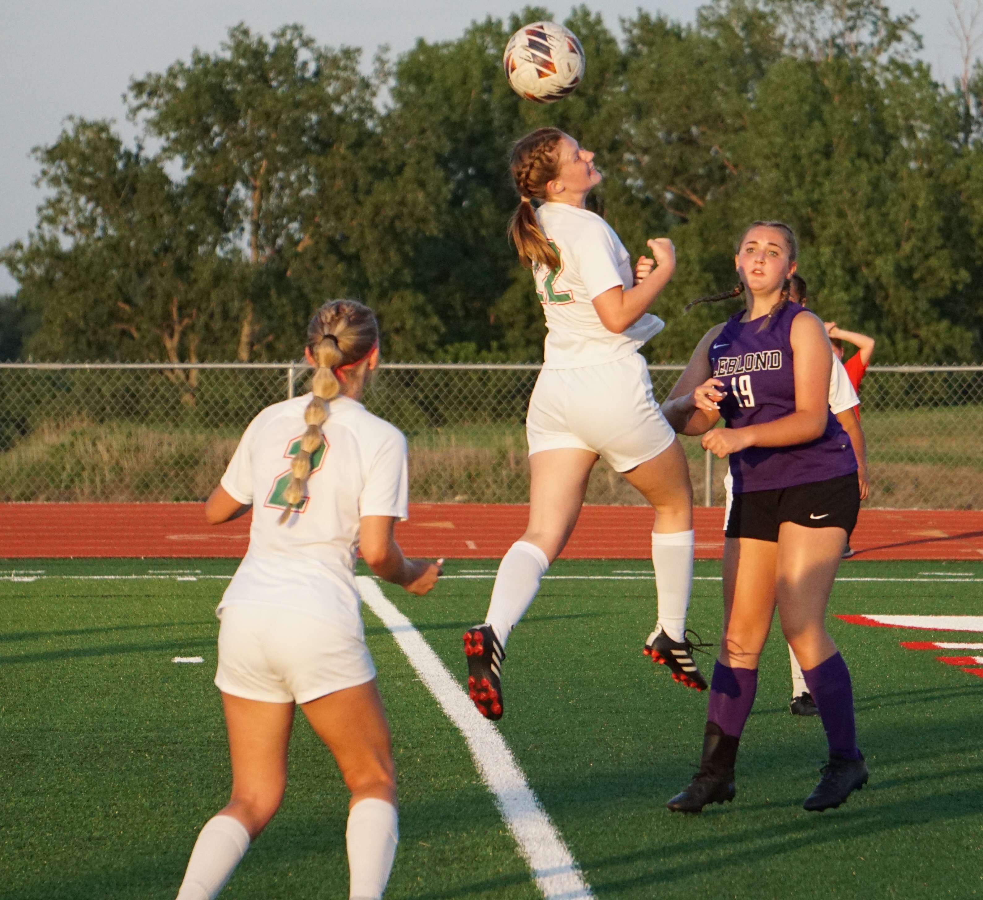 Paige Bennett (22) with a header.