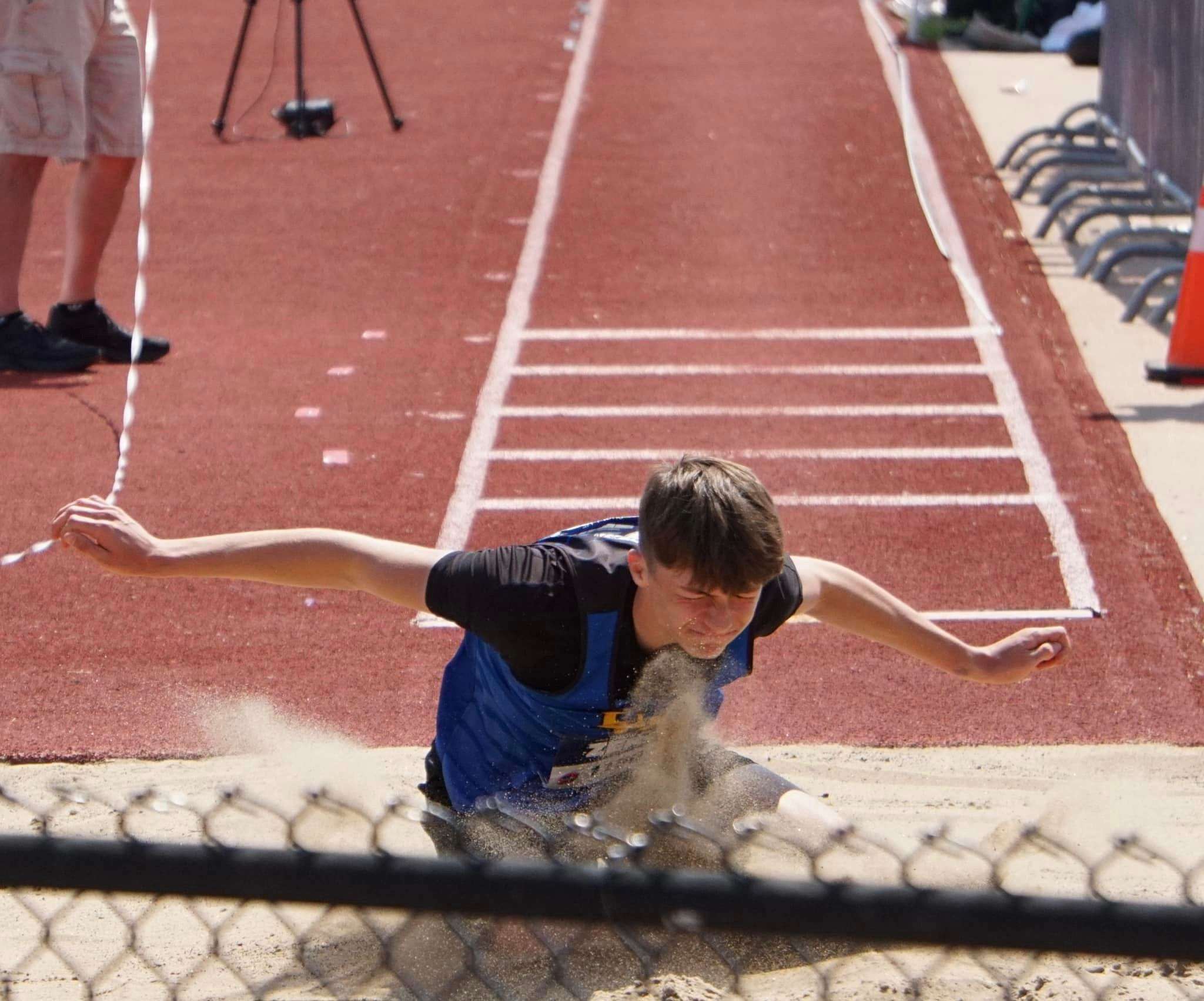 Trey Johnson competes in triple jump at state. Photo by Tommy Rezac.