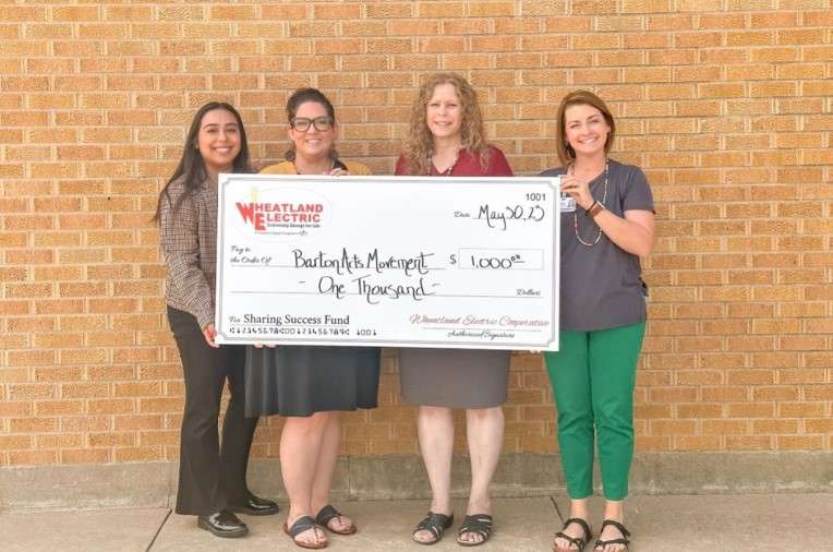 Wheatland Electric Cooperative member services and key accounts manager Mary Hoisington (second from right) presents a $1,000 Sharing Success grant to Barton Arts Movement represented by Andrea Bauer (far right). Grant funds will be used toward the sunflower mural project on the Sunflower Building which houses the Great Bend Chamber of Commerce represented by Edith Solorzano and Megan Barfield (left).