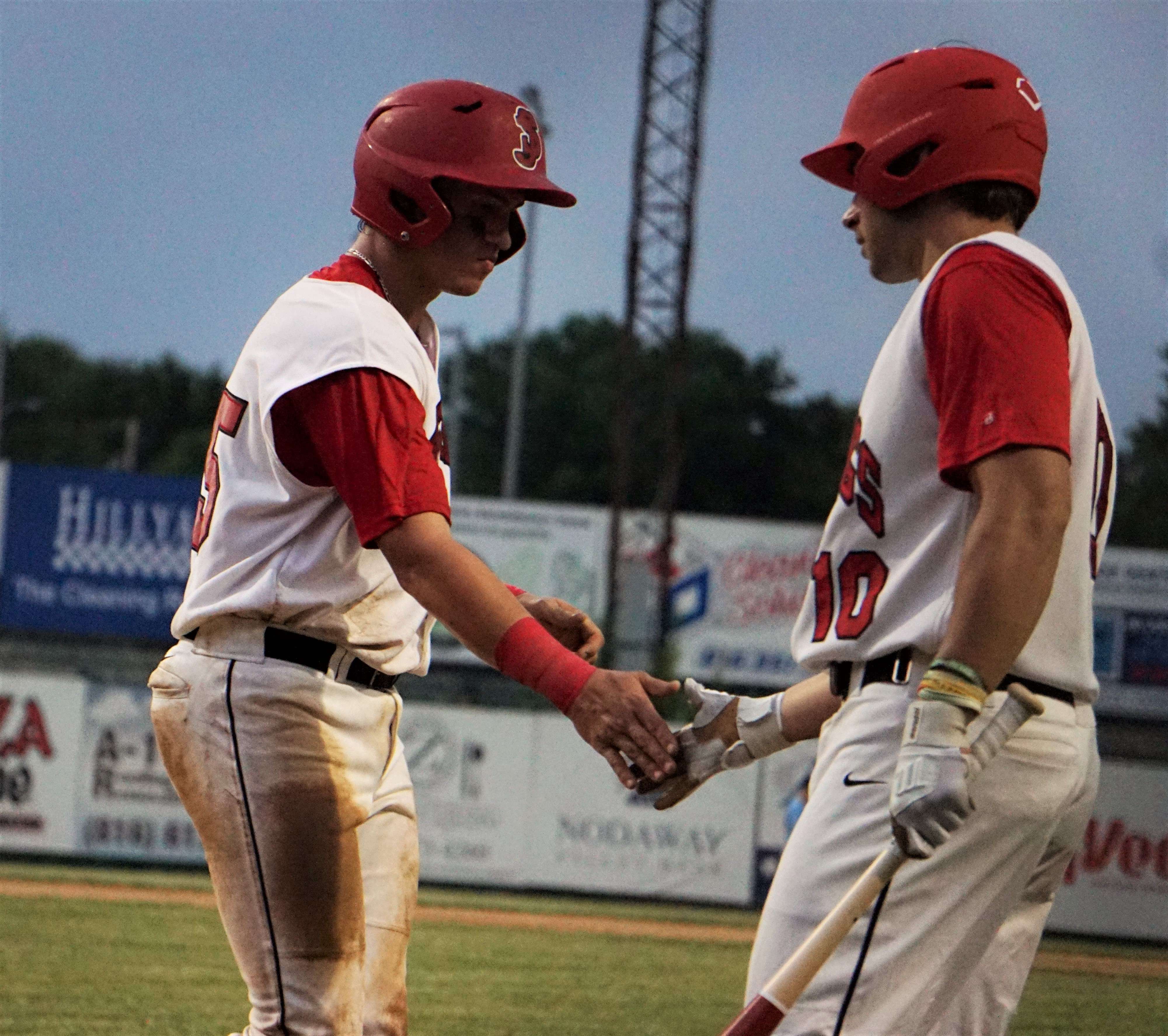 Ike Book (right) and Oscar Pegg (left) celebrate a run scored. Stock photo by Tommy Rezac.