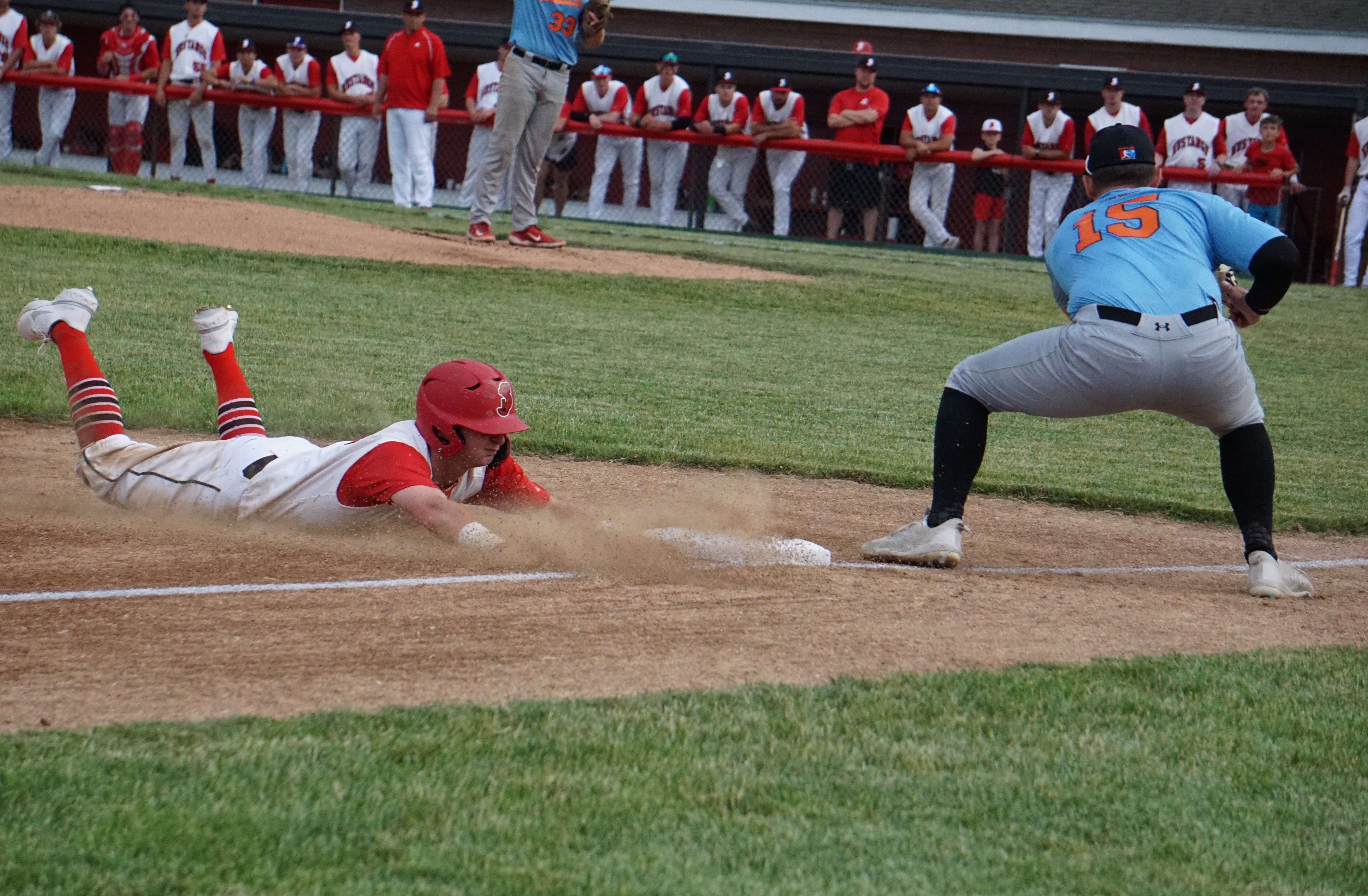 Cole Slibowski slides into third base.