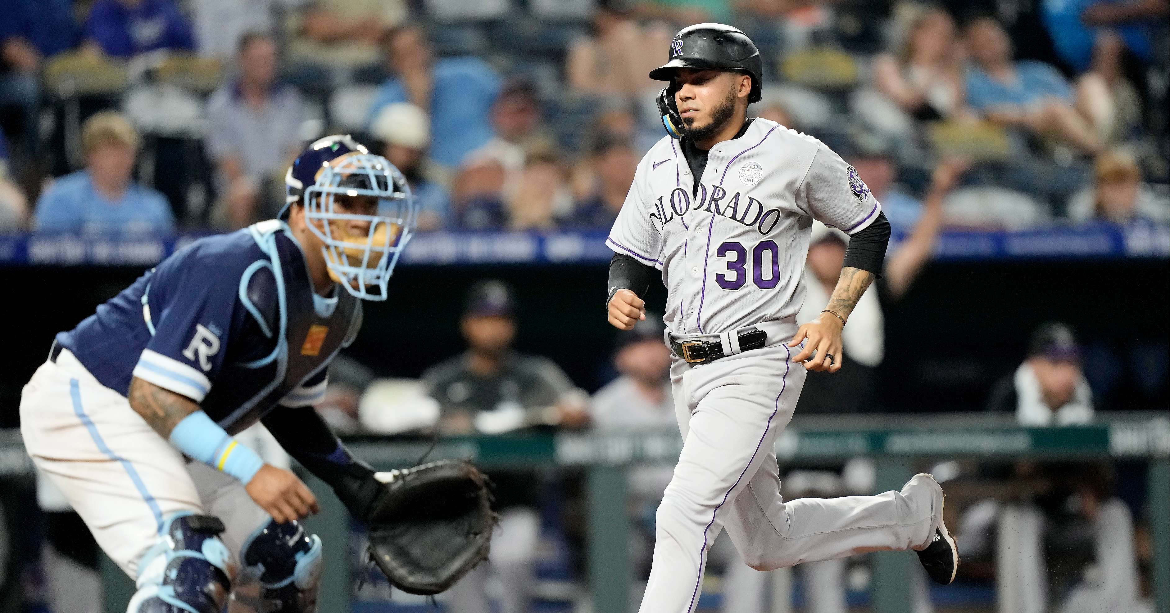 Colorado Rockies' Harold Castro (30) runs home to score on a two-run double by Nolan Jones during the eighth inning of a baseball game against the Kansas City Royals Friday, June 2, 2023, in Kansas City, Mo. (AP Photo/Charlie Riedel)