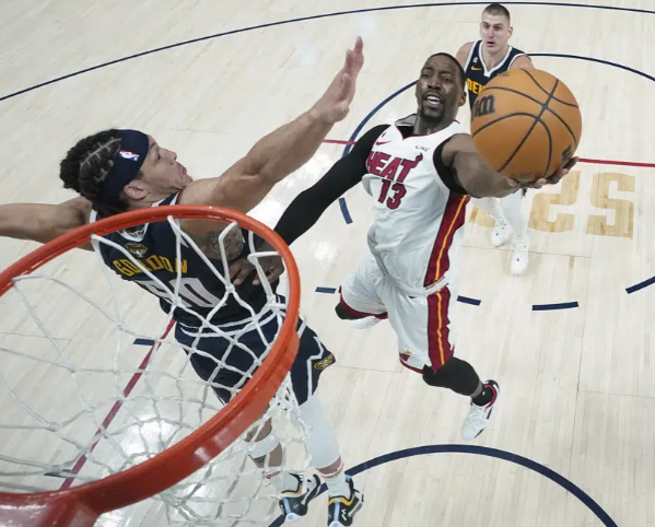 Miami Heat center Bam Adebayo (13) shoots the ball while defended by Denver Nuggets forward Aaron Gordon, left, during the second half of Game 2 of basketball's NBA Finals, Sunday, June 4, 2023, in Denver. (AP Photo/Mark J. Terrill, Pool)