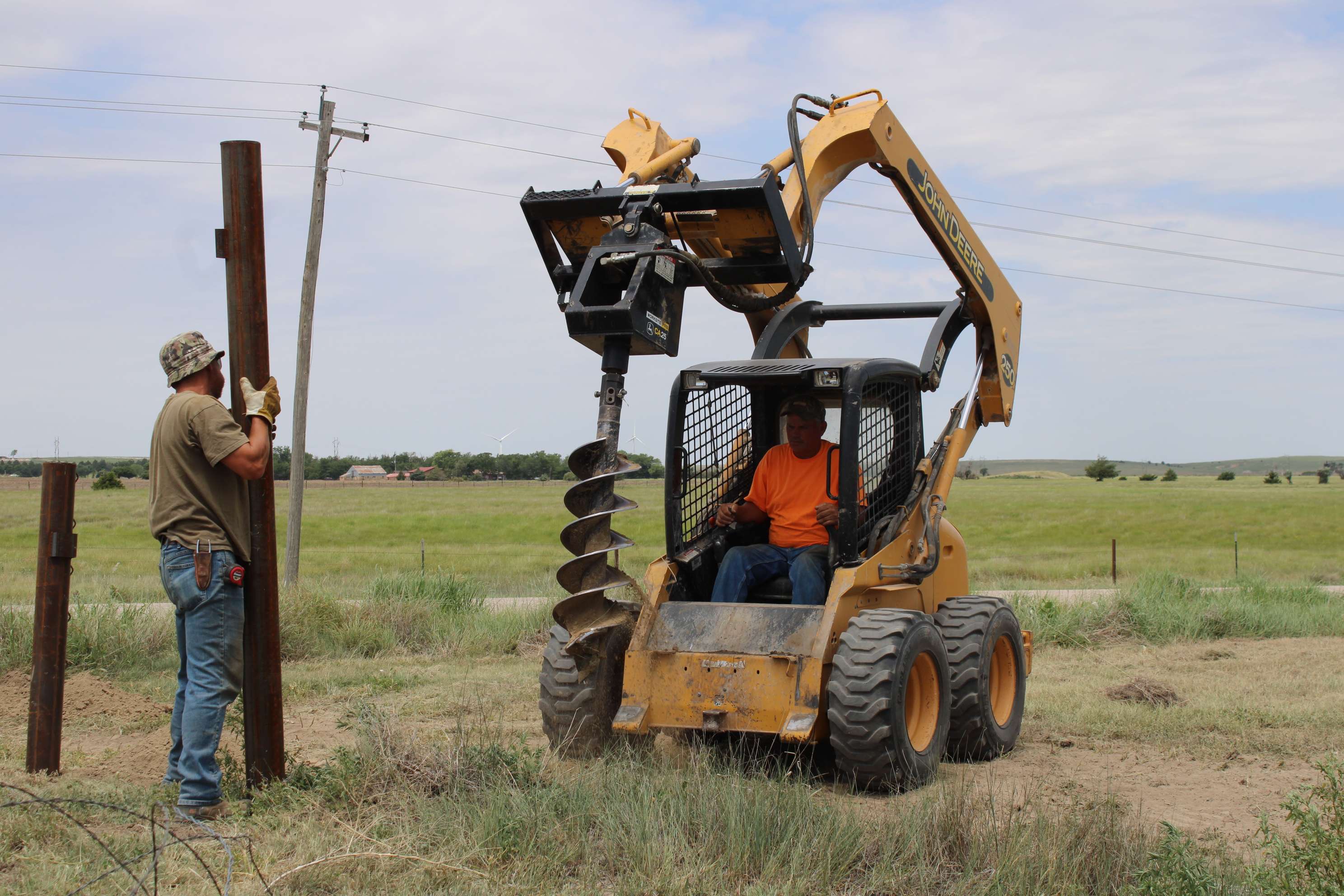 John Dreiling and Chad Jury of J and C Fencing drill post holes and set posts for new University Farm fencing. Courtesy photo<br>
