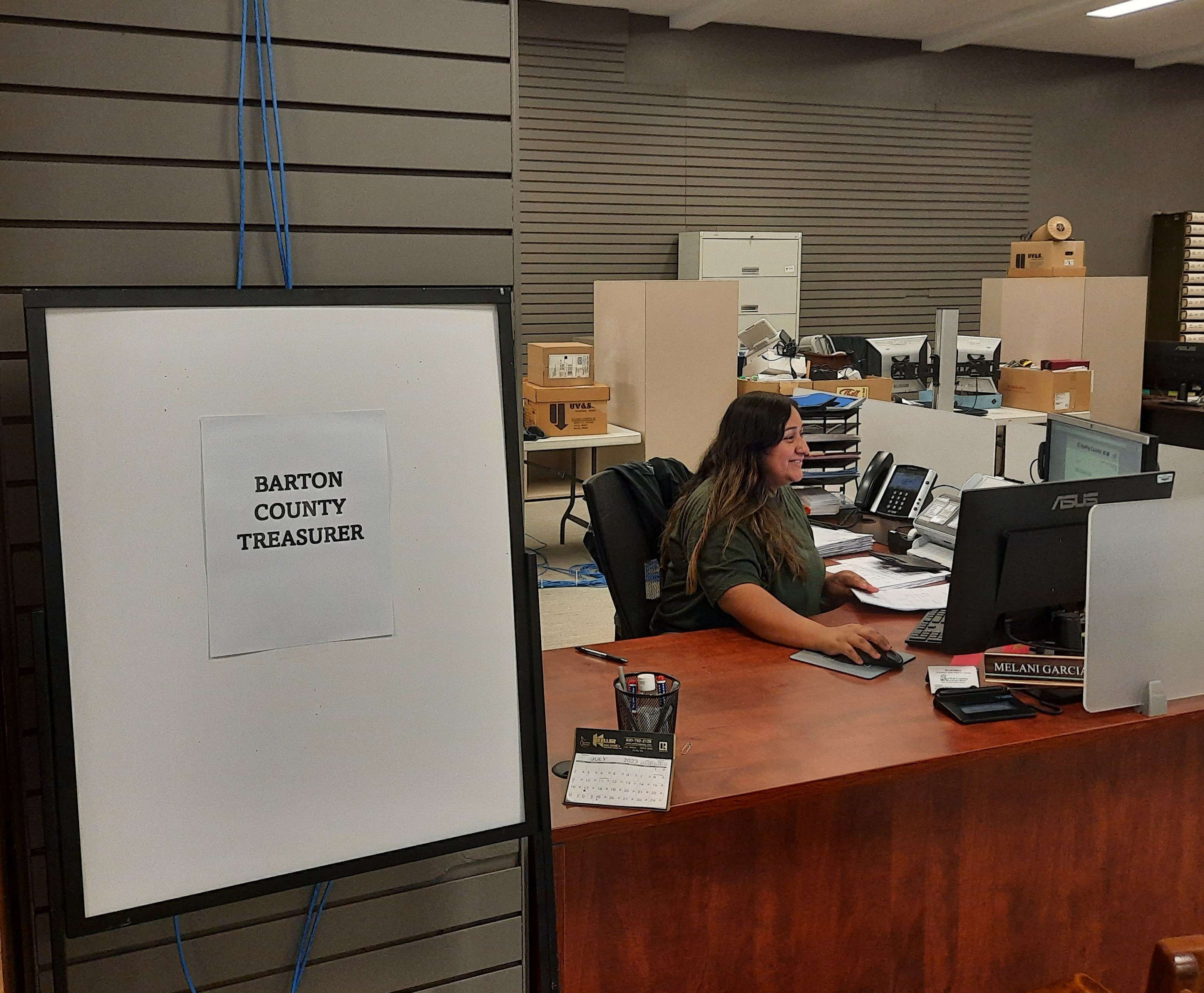 Melanie Garcia with the Barton County Treasurer's Office was at her new desk inside the former JC Penney Building on Friday.